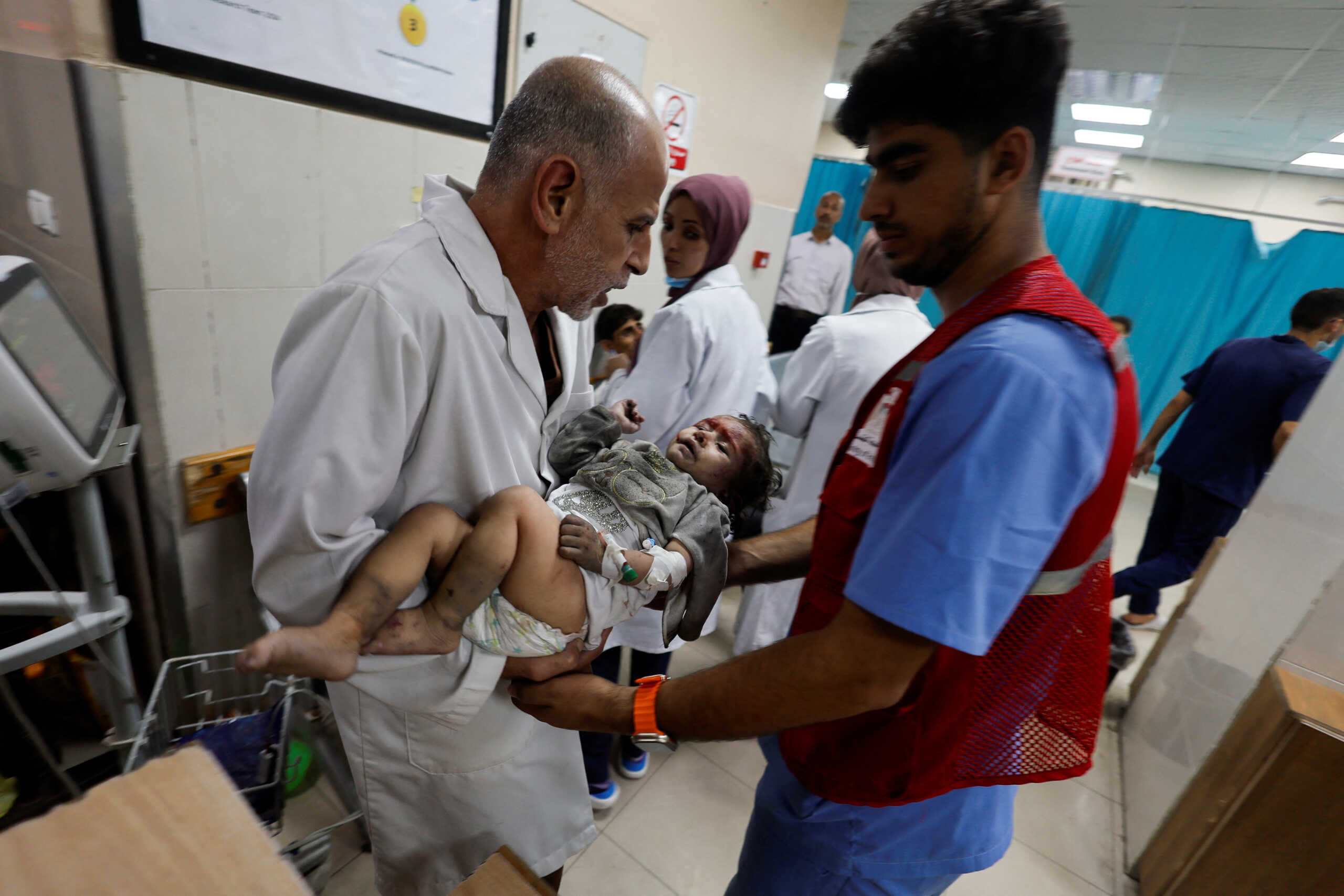 A Palestinian child wounded in an Israeli strike is assisted at Nasser hospital, amid the ongoing conflict between Israel and Palestinian Islamist group Hamas, in Khan Younis in the southern Gaza Strip November 18, 2023. REUTERS