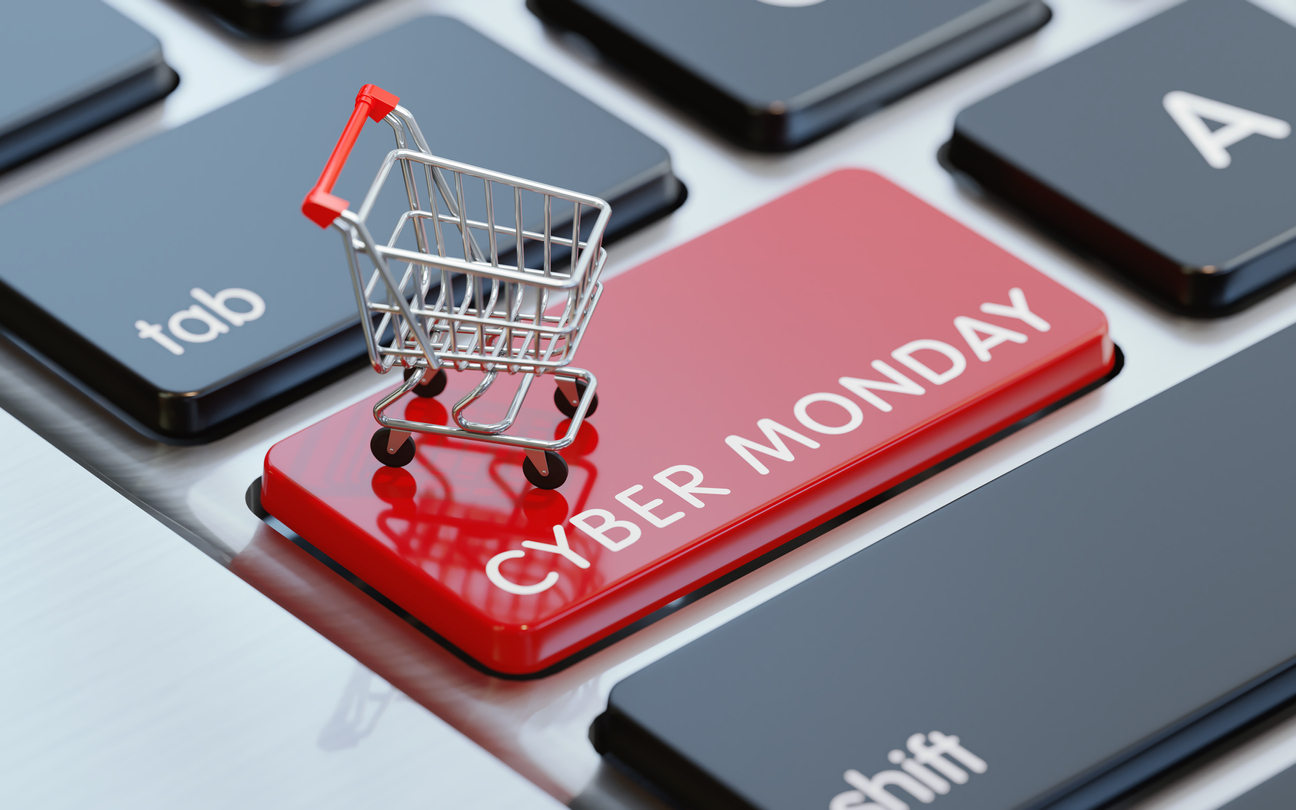 Modern computer keyboard with a shopping cart and a red Cyber Monday button.  Horizontal composition with selective focus and copy space. Great use for shopping and Cyber Monday related concepts.