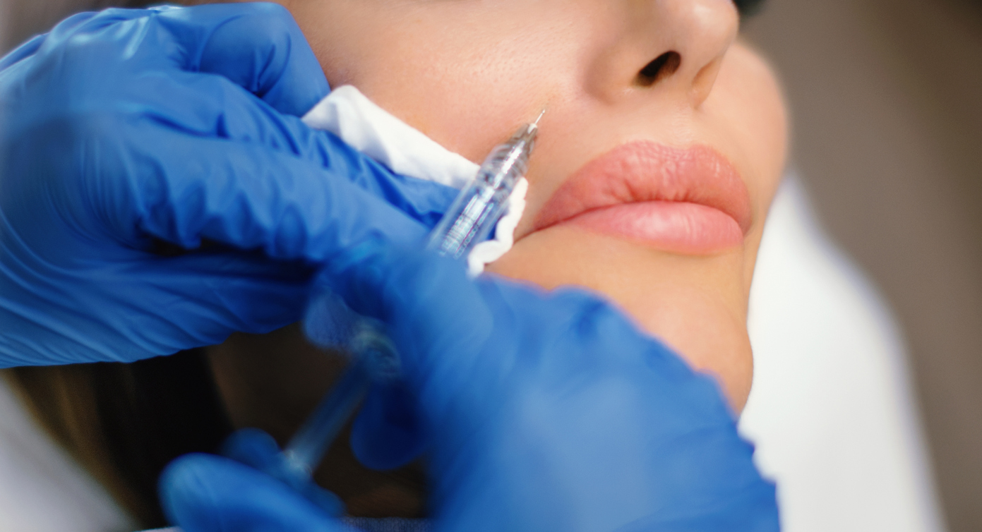 Unrecognizable woman having nasolabial folds done at private medical clinic.