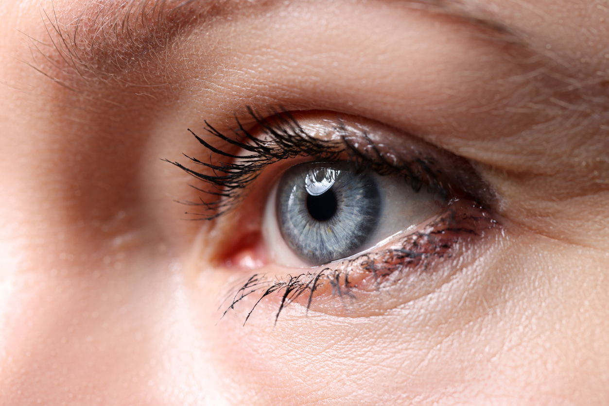 Beautiful blue female eye looking somewhere into distance closeup