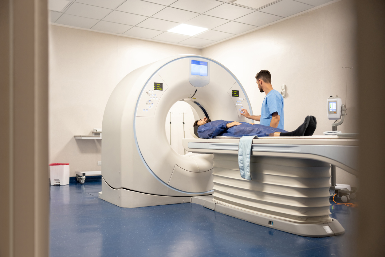 Doctor getting a patient ready for a medical scan at the hospital - healthcare and medicine concepts