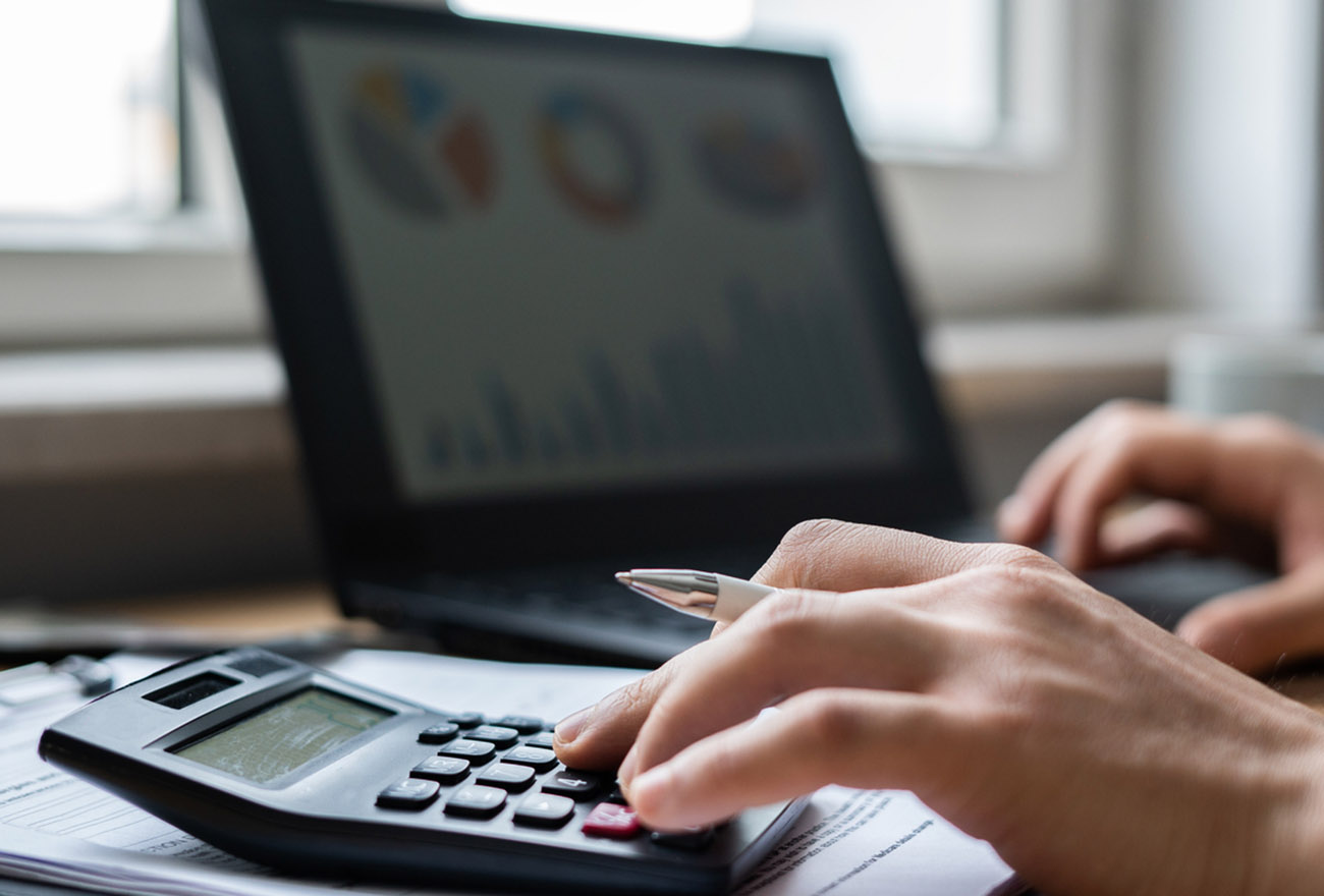 Close-up Man paying bills from laptop