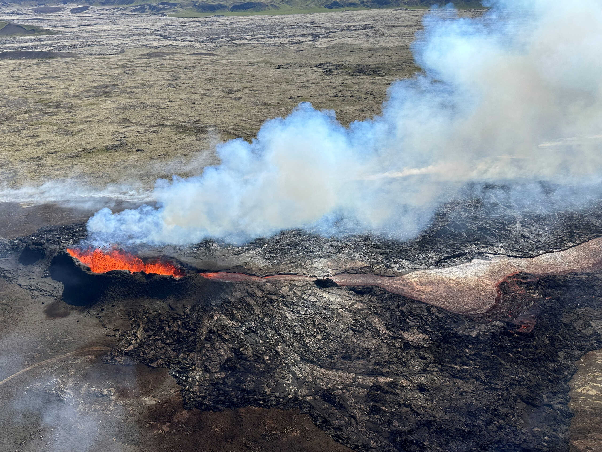 FILE PHOTO: Lava spurts and flows after the eruption of a volcano in the Reykjanes Peninsula, Iceland, July 12, 2023, as seen in this handout picture taken from a Coast Guard helicopter. Civil Protection of Iceland