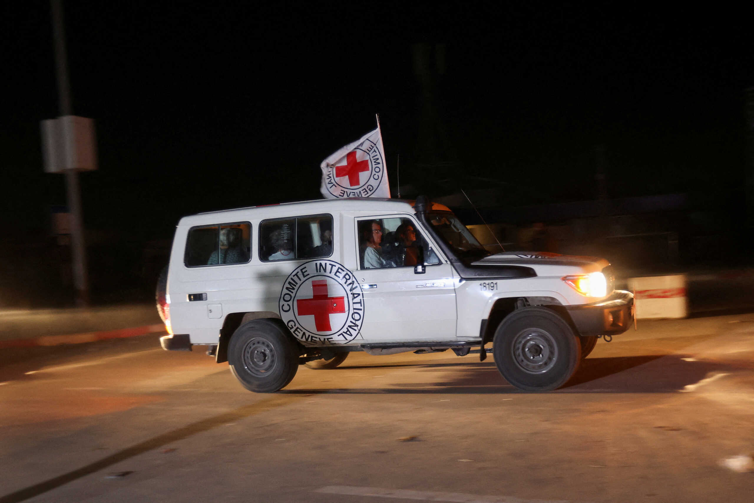 A red cross vehicle drives, as part of a convoy believed to be carrying hostages abducted by Hamas militants during the October 7 attack on Israel, arrives at Rafah border, amid a hostages-prisoners swap deal between Hamas and Israel, in the southern Gaza Strip November 24, 2023. REUTERS