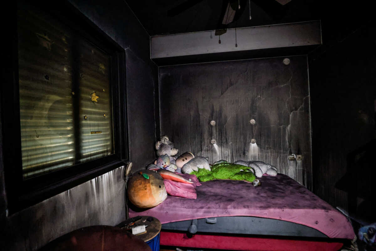 FILE PHOTO: Teddy bears are placed on the bed in a saferoom, which is also used as a children's room, and are covered with soot following a deadly infiltration by Hamas gunmen from the Gaza Strip, in Kibbutz Beeri in southern Israel October 22, 2023. REUTERS