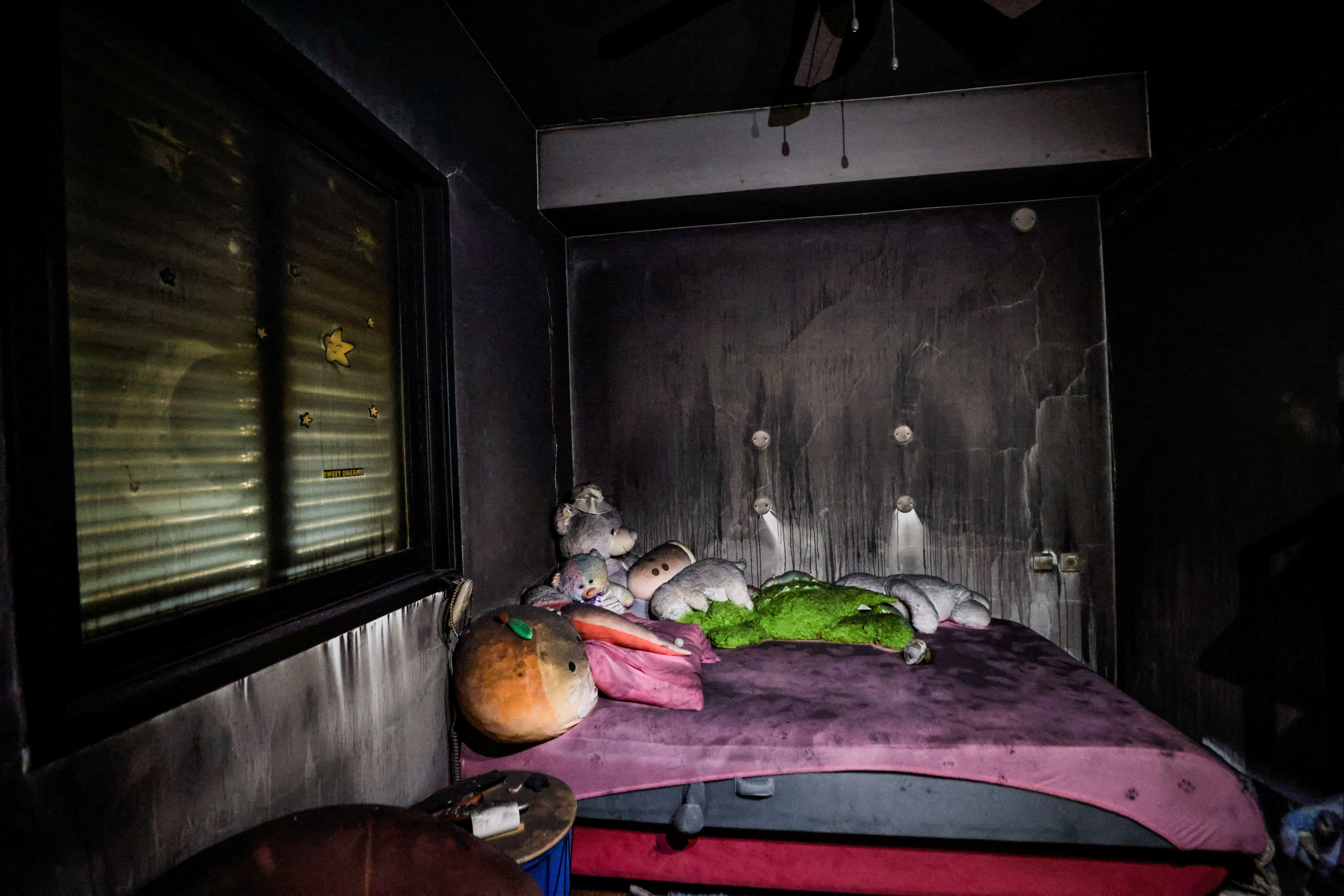 FILE PHOTO: Teddy bears are placed on the bed in a saferoom, which is also used as a children's room, and are covered with soot following a deadly infiltration by Hamas gunmen from the Gaza Strip, in Kibbutz Beeri in southern Israel October 22, 2023. REUTERS
