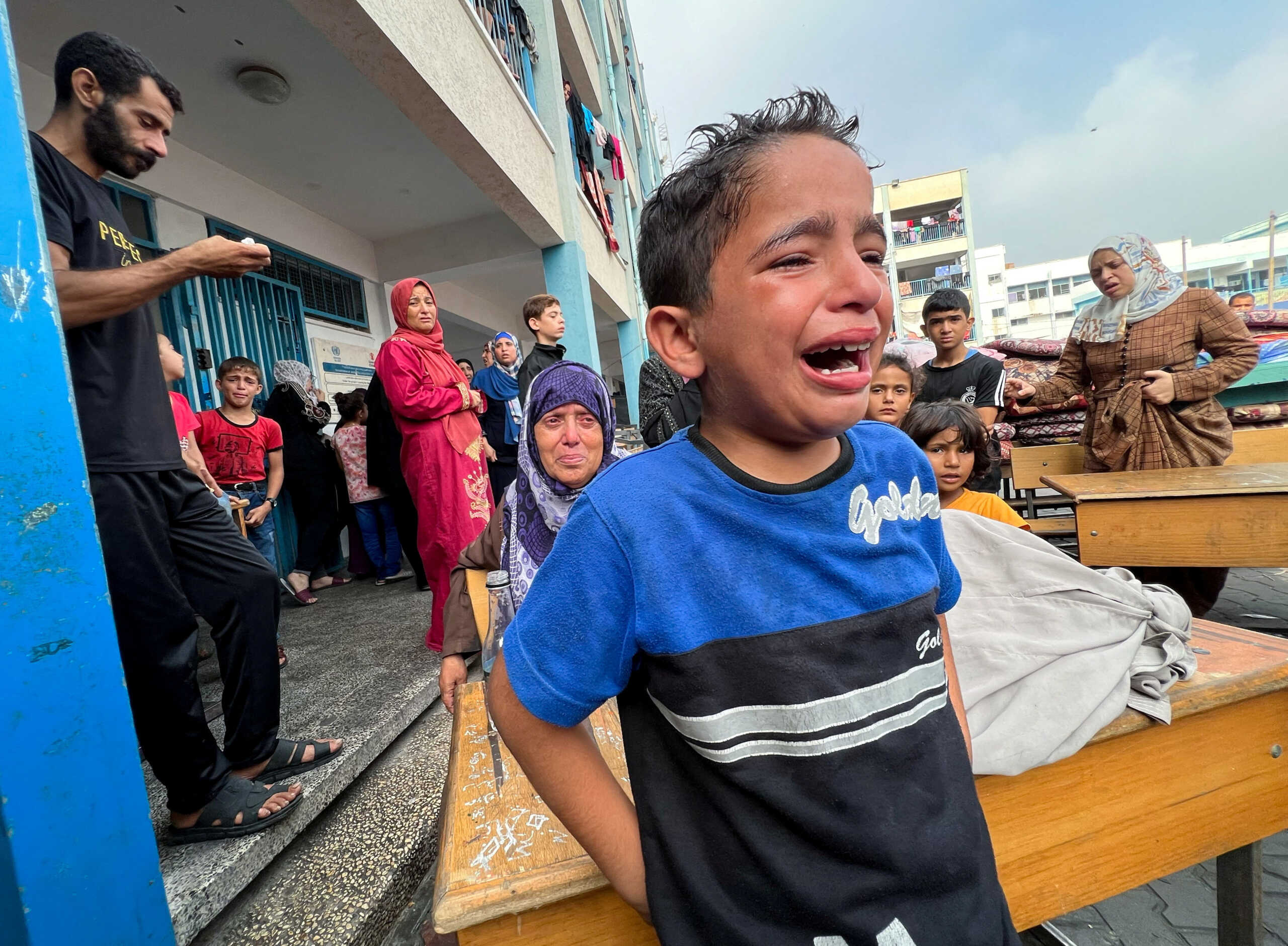 A Palestinian boy reacts at the damages at a UN-run school sheltering displaced people, following an Israeli strike, in Jabalia in the northern Gaza Strip November 2, 2023. REUTERS