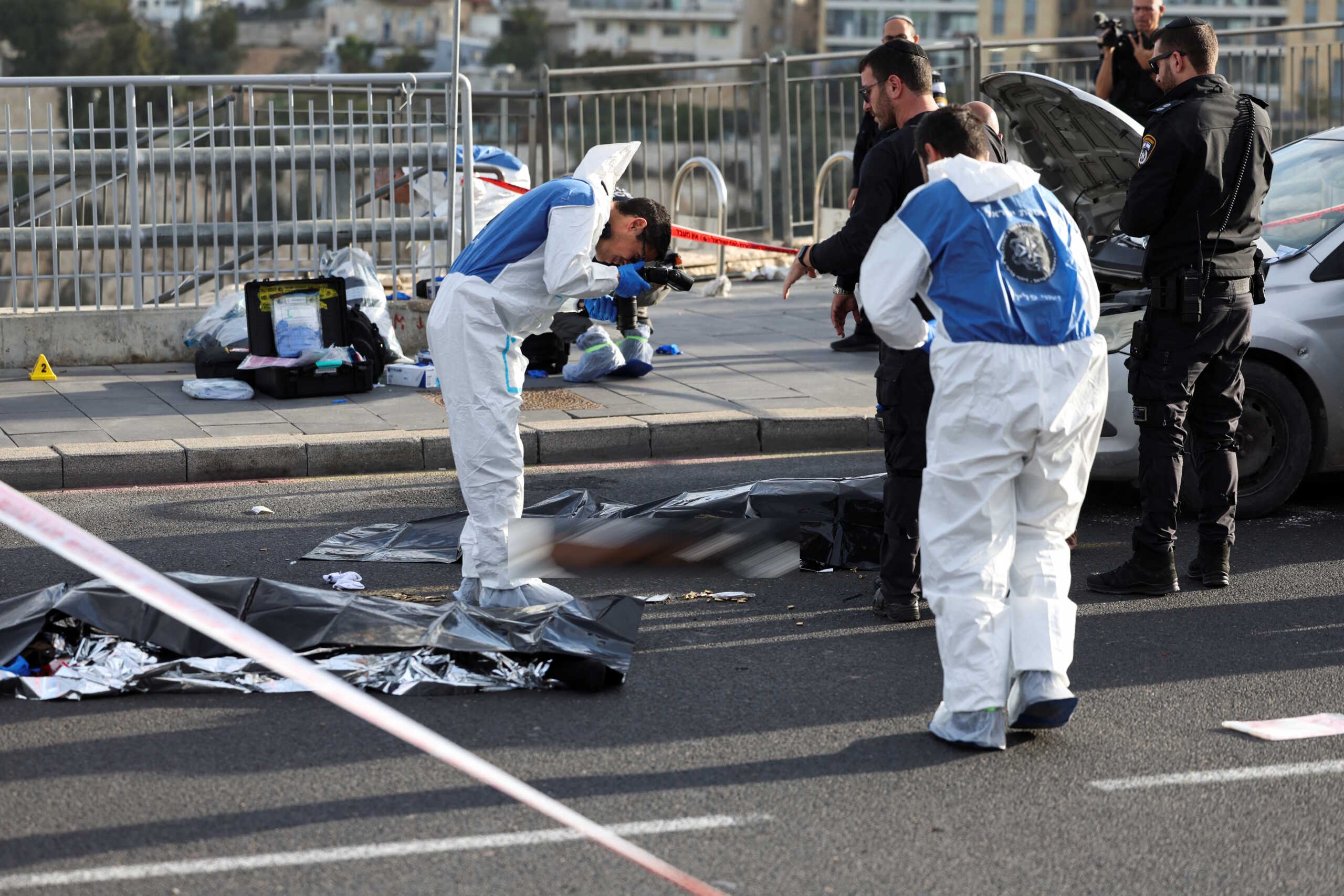 SENSITIVE MATERIAL. THIS IMAGE MAY OFFEND OR DISTURB    Israeli officials work at the scene of a violent incident in Jerusalem November 30, 2023 REUTERS