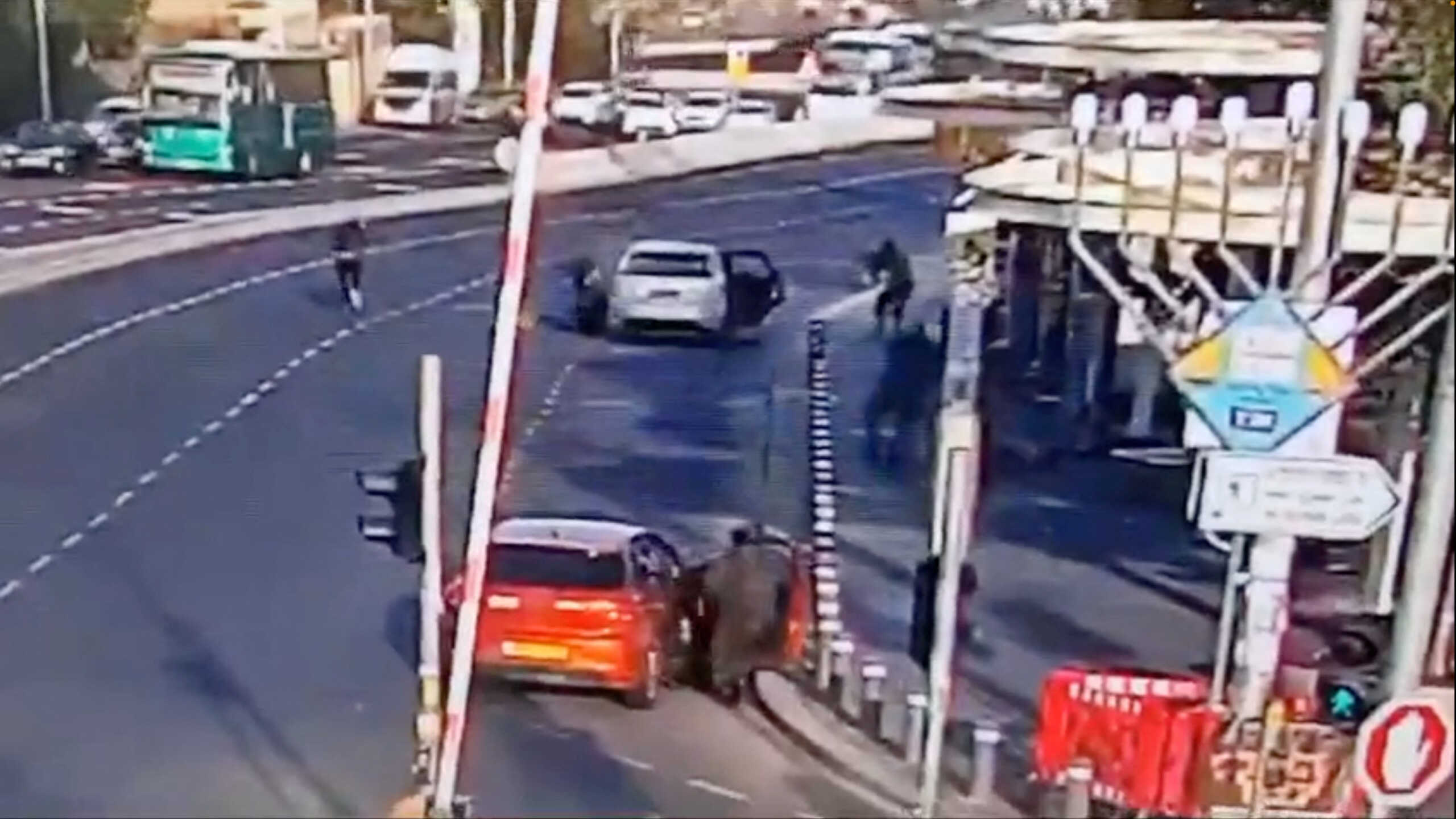 Israeli police take position as two Palestinian attackers take cover after opening fire at a bus stop at the entrance to Jerusalem, November 30, 2023, in this screengrab obtained from a handout video. Video obtained by Reuters  THIS IMAGE HAS BEEN SUPPLIED BY A THIRD PARTY. NO RESALES. NO ARCHIVES.