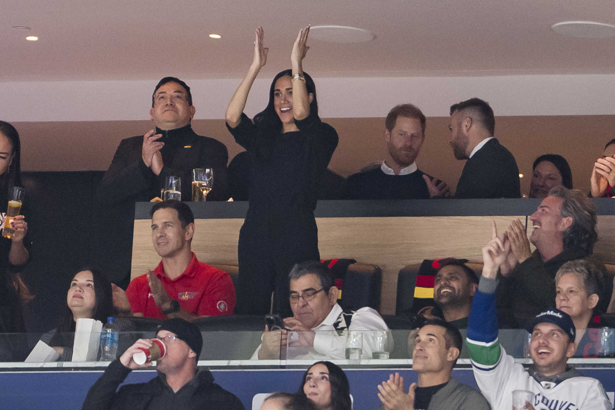 Nov 20, 2023; Vancouver, British Columbia, CAN; Prince Harry, Duke of Sussex and Meghan, Duchess of Sussex watch the Vancouver Canucks play against the San Jose Sharks at Rogers Arena. THE DUCHESS celebrates a goal scored by Vancouver Canucks defenseman Quinn Hughes (43) in the second period.  Mandatory Credit: Bob Frid-USA TODAY Sports