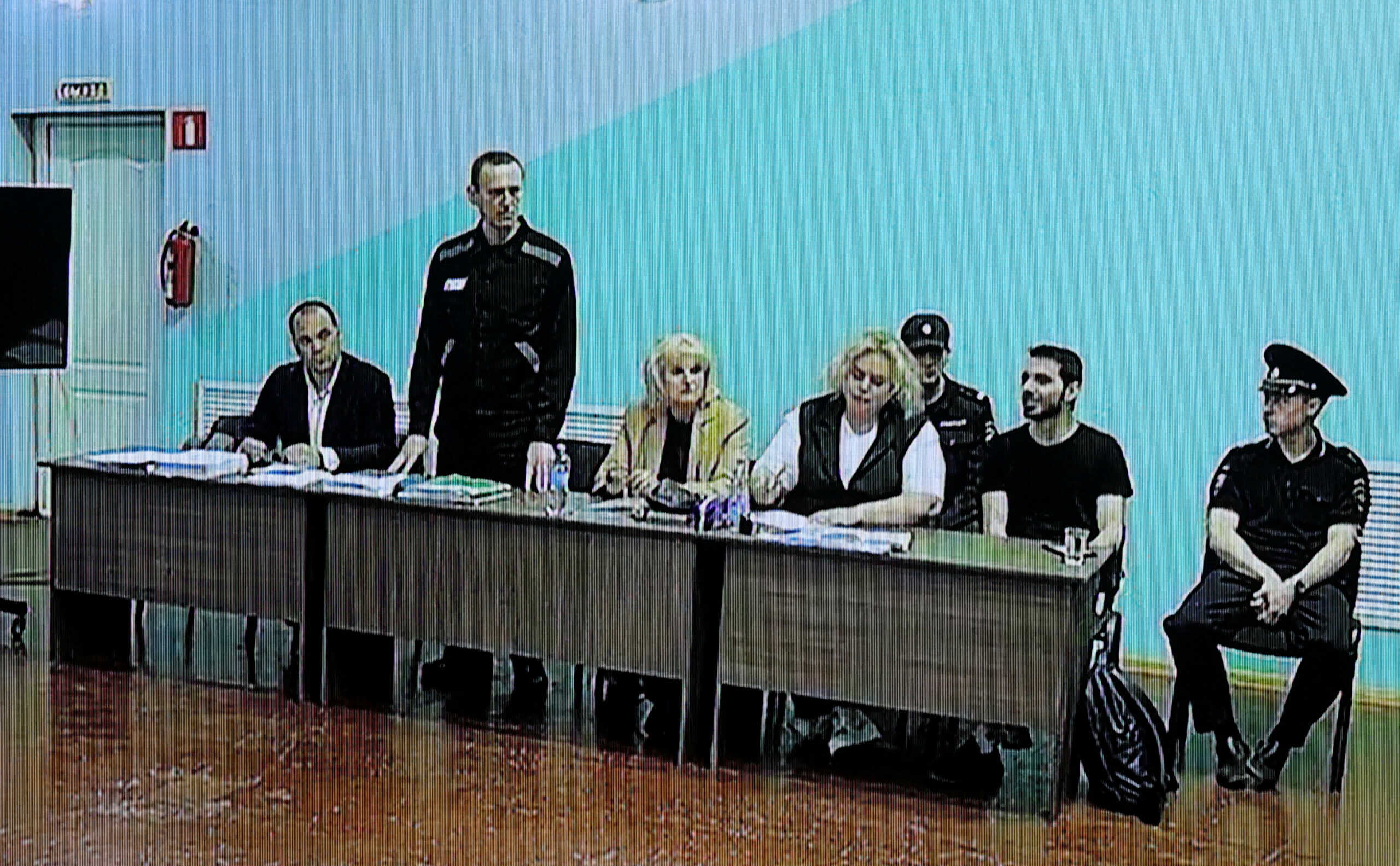 FILE PHOTO: Russian opposition politician Alexei Navalny, his lawyers Olga Mikhailova and Vadim Kobzev and other participants are seen on a screen via a video link during an external hearing of the Moscow City Court in a new criminal case against Navalny on numerous charges, including the creation of an extremist organization, at the IK-6 penal colony in the Vladimir region, Russia, June 19, 2023. REUTERS