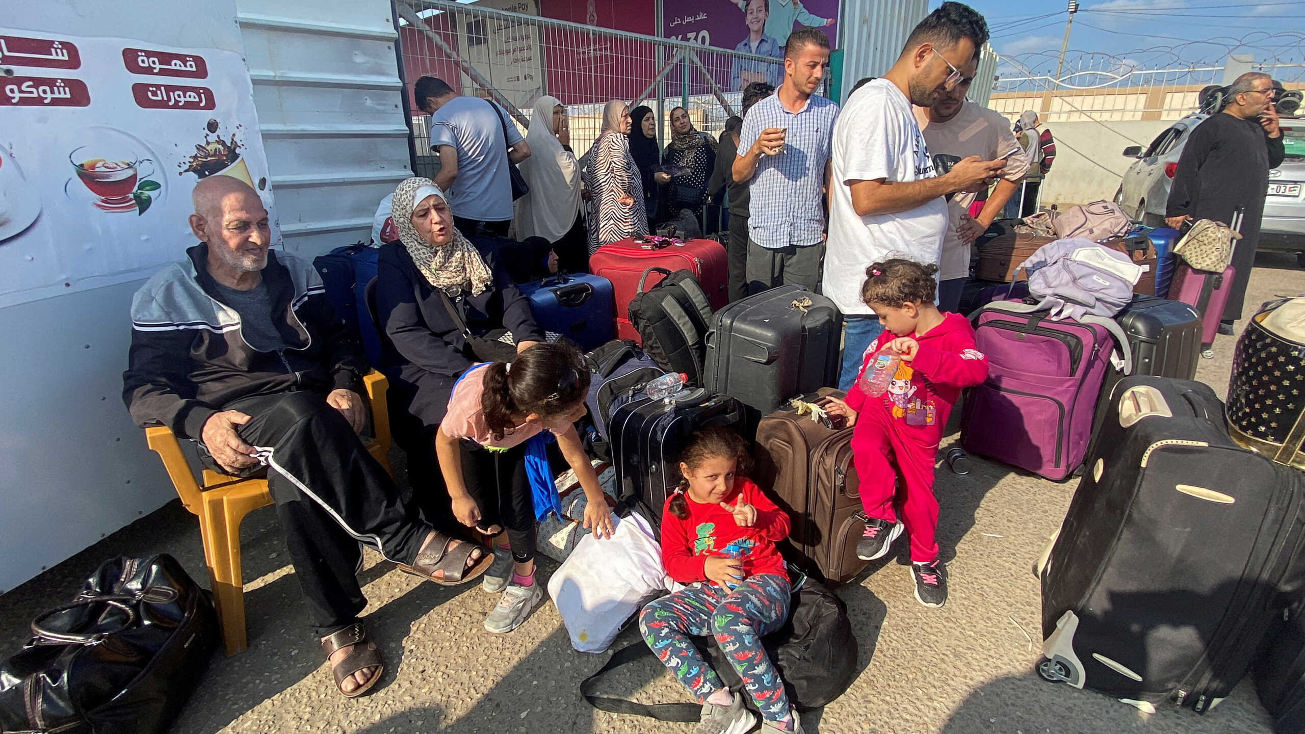 Palestinians with dual citizenship wait outside the Rafah border crossing with Egypt, in the hope of getting permission to leave Gaza, amid the ongoing conflict between Israel and Palestinian Islamist group Hamas, in Rafah in the southern Gaza Strip, November 1, 2023. REUTERS