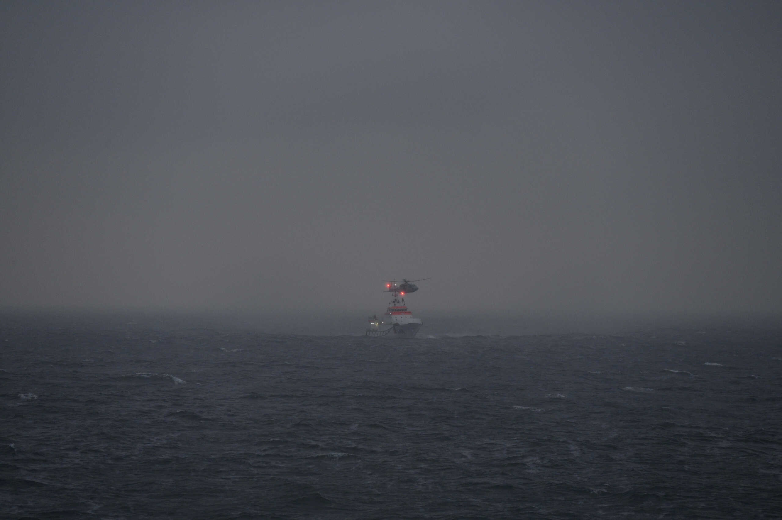 A helicopter of Germany's Marine lowers a rescuer of the Maritime Incident Response Group MIRG aboard the rescue ship Hermann Marwede of German Maritime Search and Rescue Service DGzRS (Deutsche Gesellschaft zur Rettung Schiffbruechiger) following the collision of two freighter ships, the British-flagged vessel Verity and the Bahamas-flagged freighter Polesie, in the German North Sea Bight, as Germany's Central Command for Maritime Emergencies said on Tuesday, in this handout photo obtained by Reuters on October 24, 2023.  Kai Twest