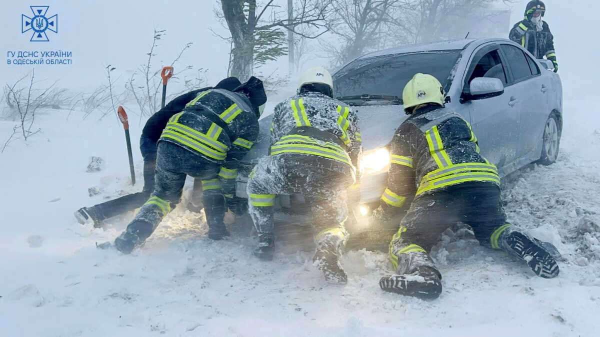 FILE PHOTO: Emergency workers release a car which stuck in snow during a heavy snow storm in Odesa region, Ukraine in this handout picture released November 27, 2023. Press service of the State Emergency Service of Ukraine in Odesa region