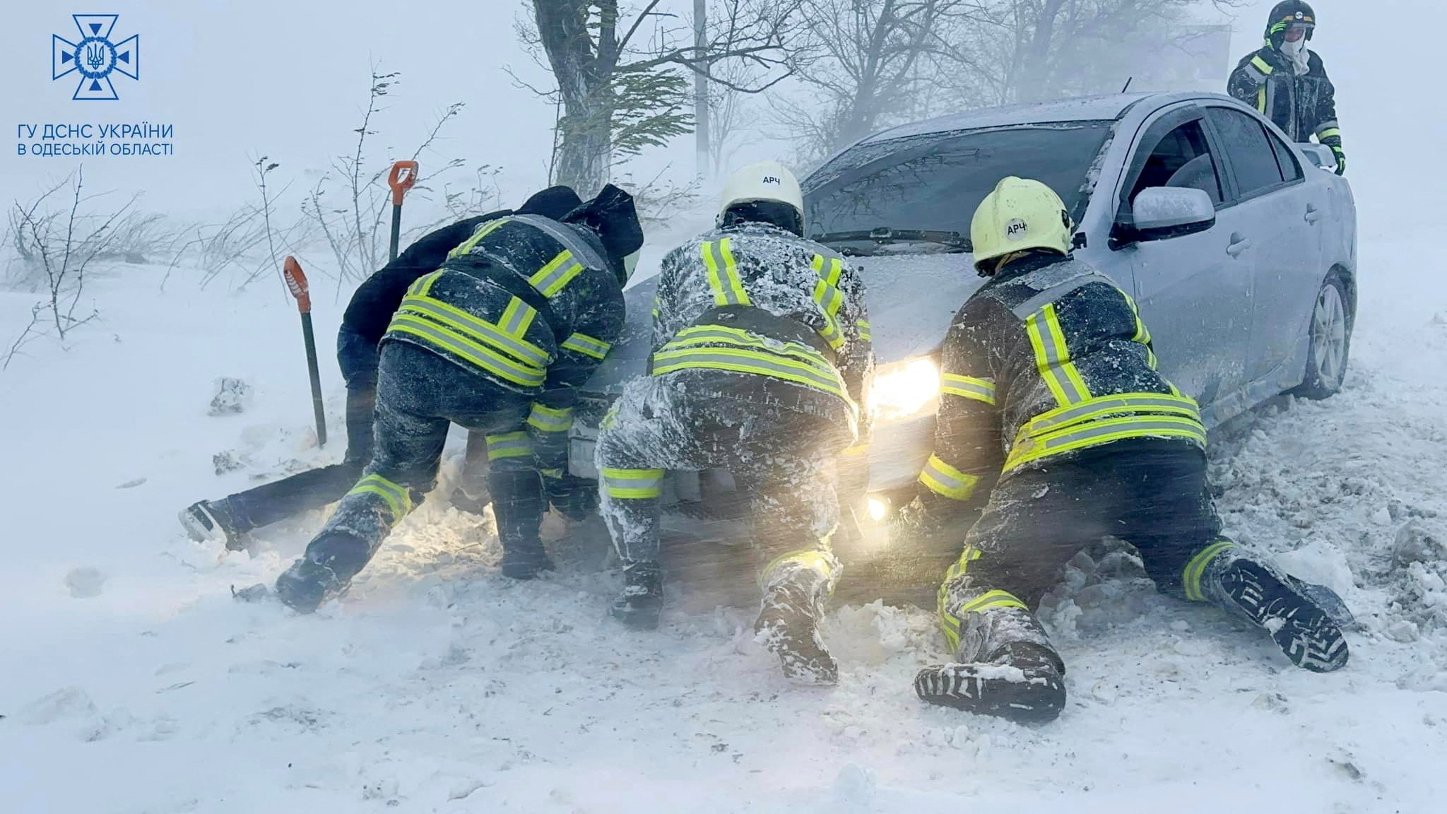 FILE PHOTO: Emergency workers release a car which stuck in snow during a heavy snow storm in Odesa region, Ukraine in this handout picture released November 27, 2023. Press service of the State Emergency Service of Ukraine in Odesa region