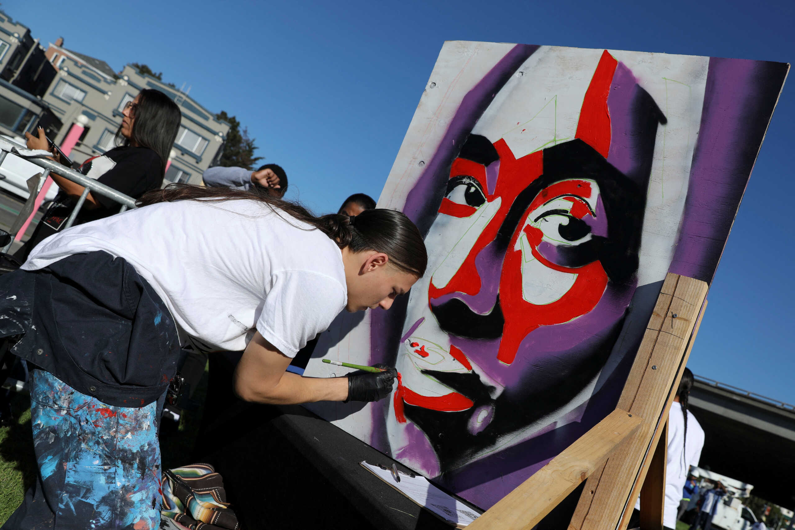 Artist Joaquin Saavedra MacCarthy Thin paints a mural depicting rapper Tupac Shakur during a ceremony for a street renaming in the rapper's honor in Oakland, California, U.S., November 3, 2023. REUTERS