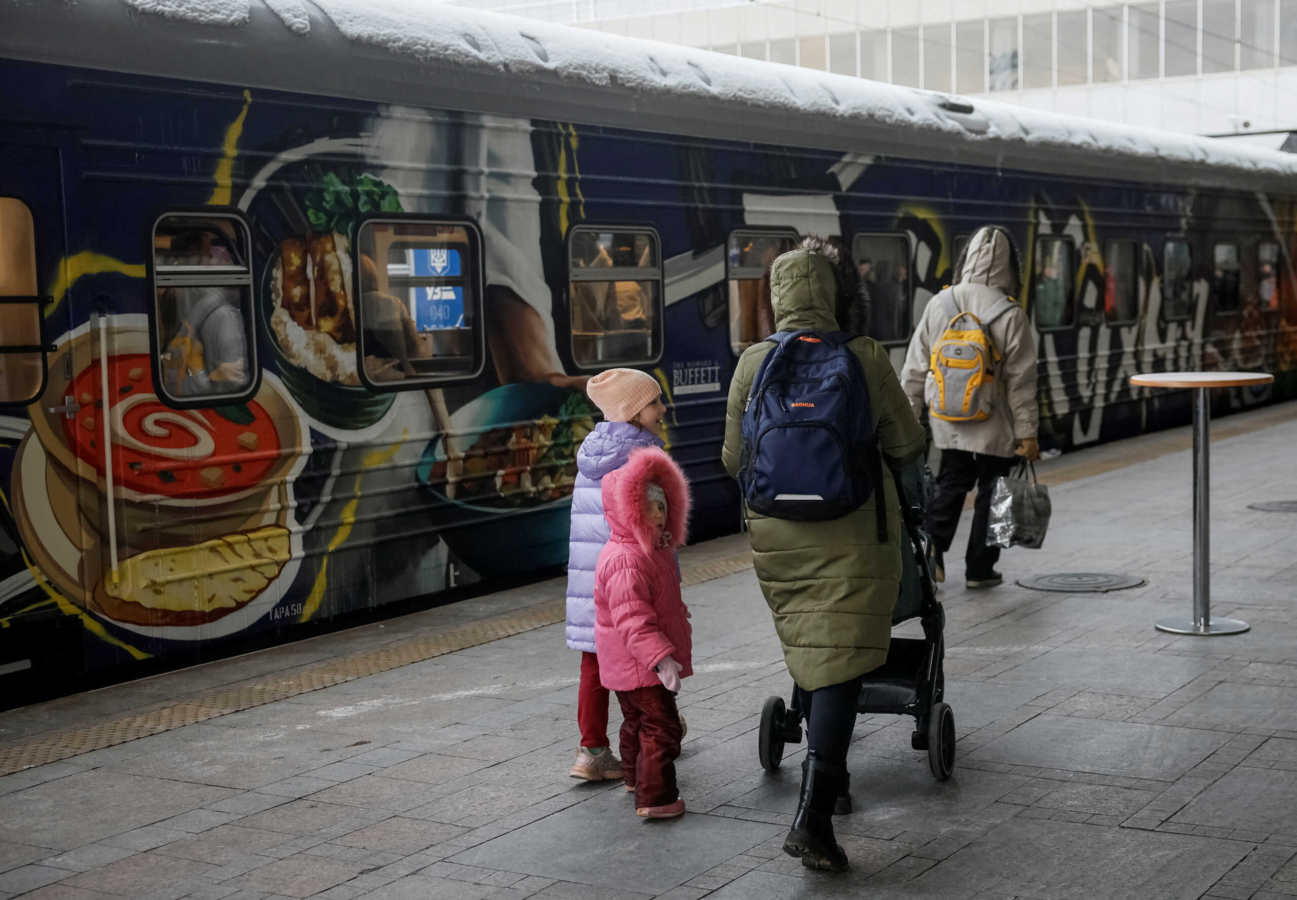 Passengers walk past a train-kitchen named Food Train designed to make and distribute up to 70,000 meals a week as the train sets off on its maiden journey from Ukrainian capital to frontline areas in the eastern region, amid Russia's attack on Ukraine, in Kyiv, Ukraine November 23, 2023. REUTERS
