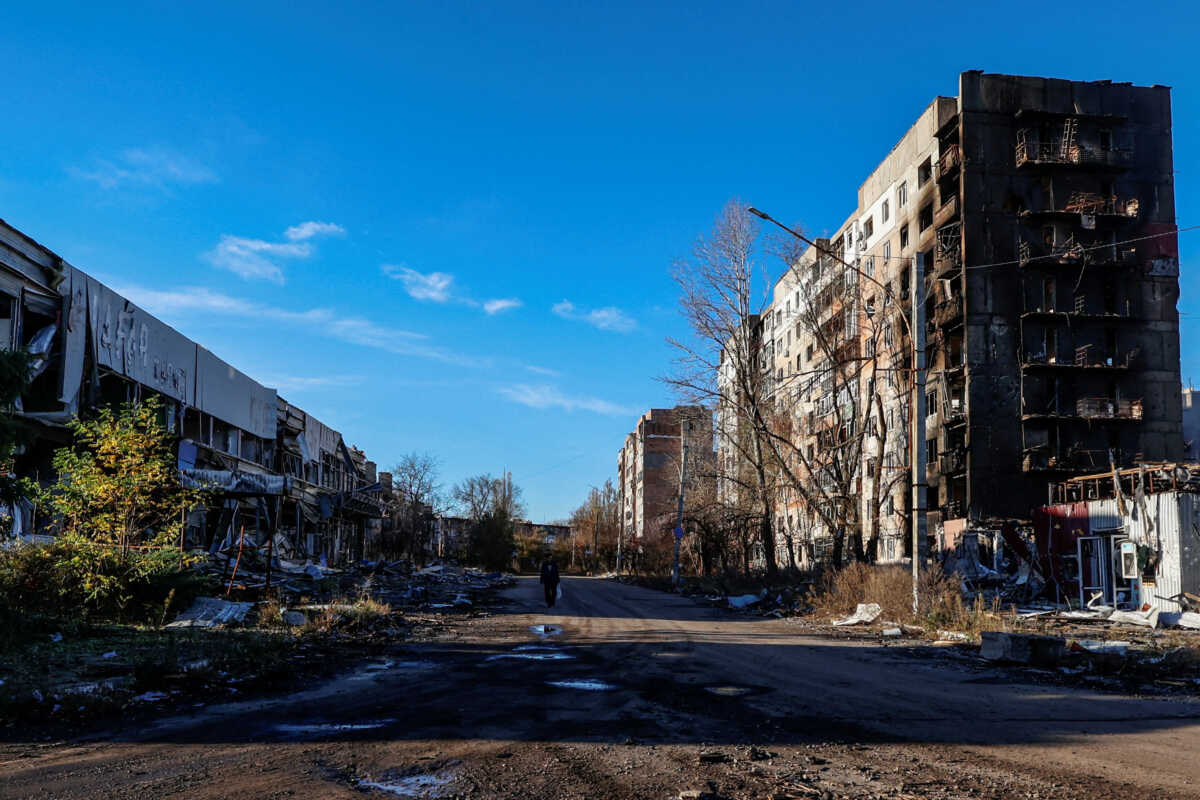 FILE PHOTO: A local resident walks next to residential buildings heavily damaged by Russian military strikes in the front line town of Avdiivka, amid Russia's attack on Ukraine, in Donetsk region, Ukraine November 8, 2023. Radio Free Europe