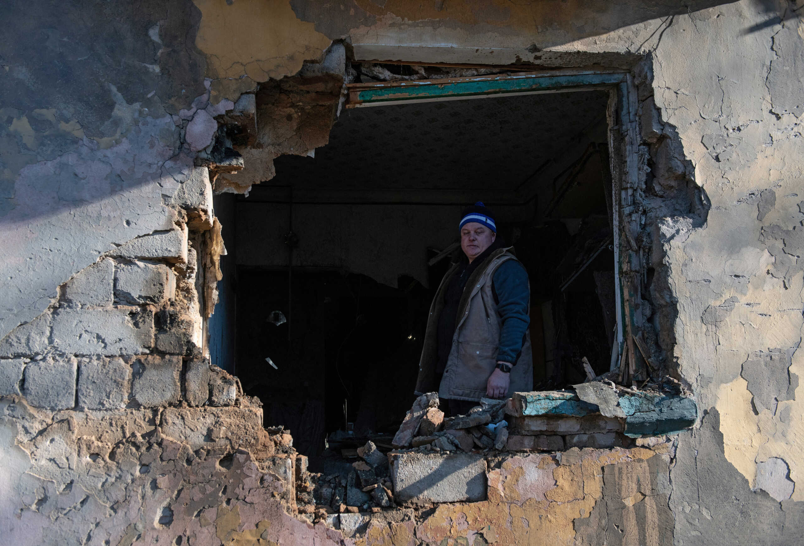 A local resident stands inside an apartment damaged by recent shelling in the course of Russia-Ukraine conflict in Donetsk, Russian-controlled Ukraine, November 28, 2023. REUTERS