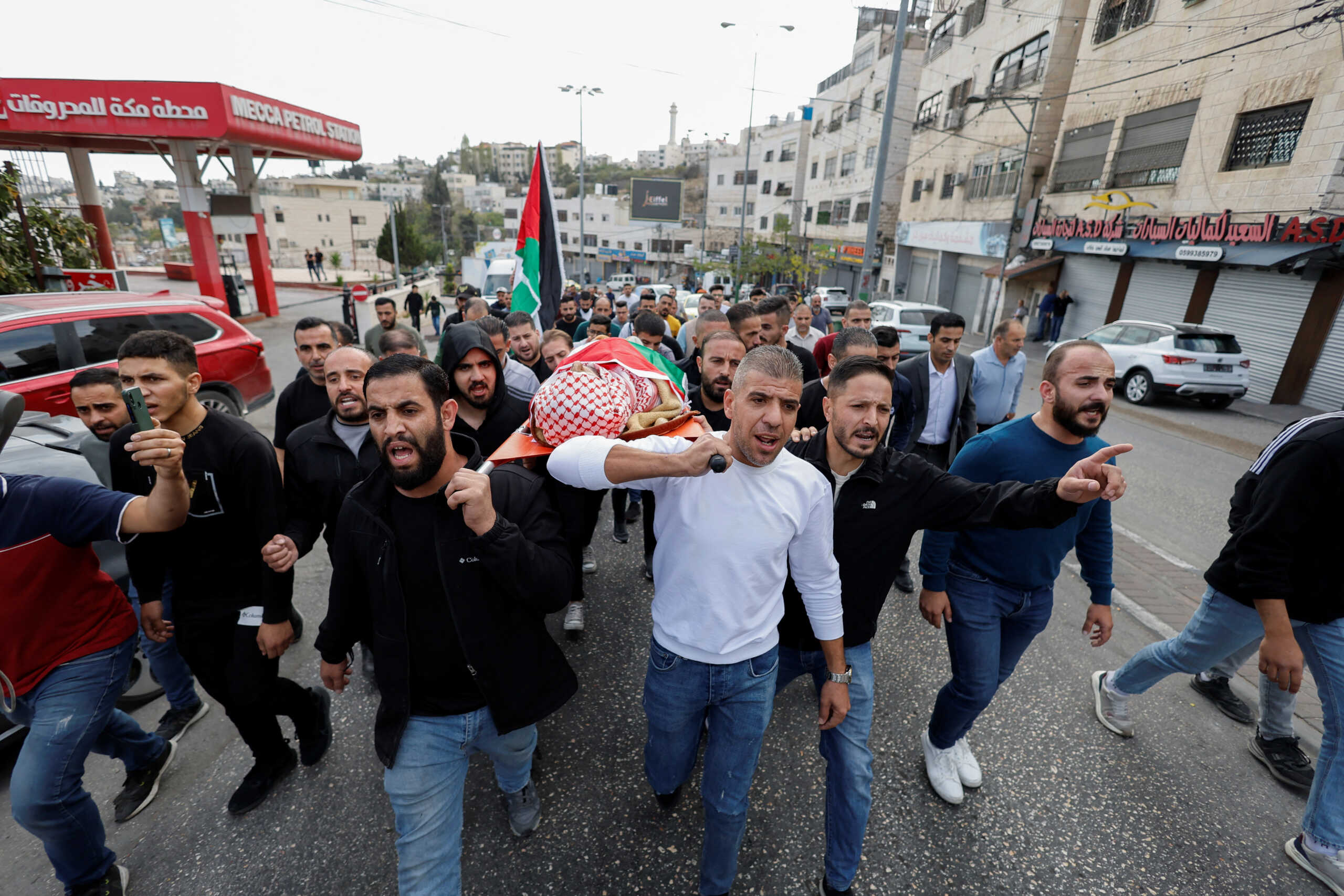 SENSITIVE MATERIAL. THIS IMAGE MAY OFFEND OR DISTURB Mourners carry the body of 66-year Palestinian Issa Qadi who was killed in an Israeli raid, during his funeral in Hebron in the Israeli-occupied West Bank, November 13, 2023. REUTERS