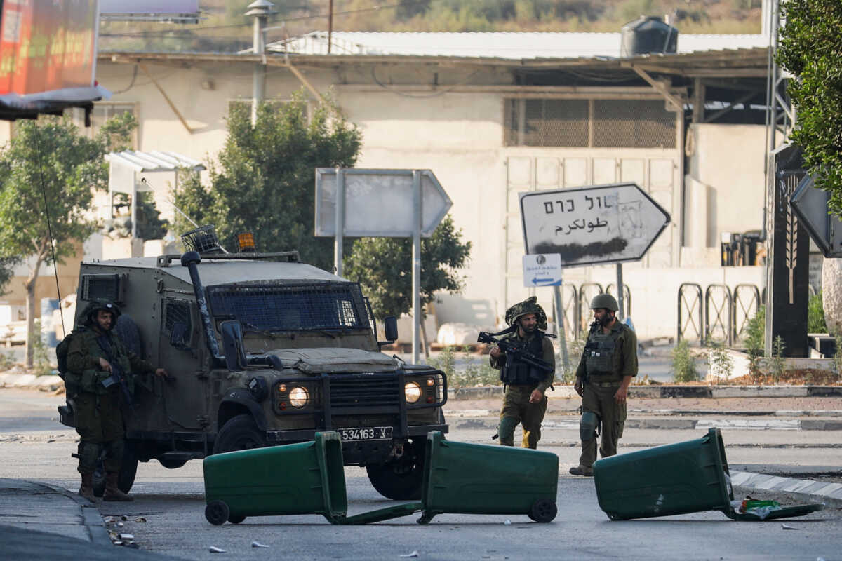 Israeli troops stand guard after settlers' attack in Deir Sharaf, near Nablus in the Israeli-occupied West Bank November 2, 2023. REUTERS