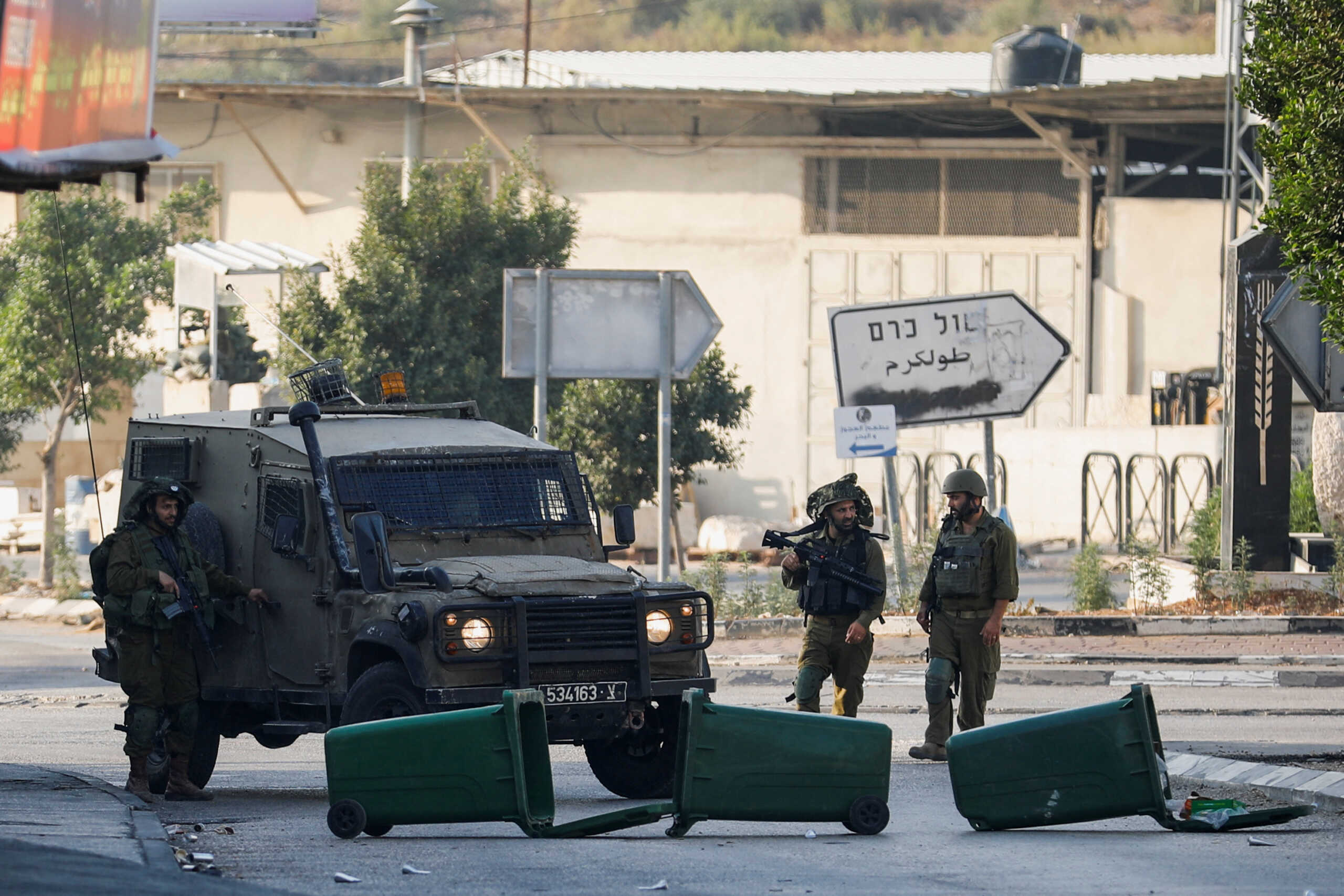 Israeli troops stand guard after settlers' attack in Deir Sharaf, near Nablus in the Israeli-occupied West Bank November 2, 2023. REUTERS