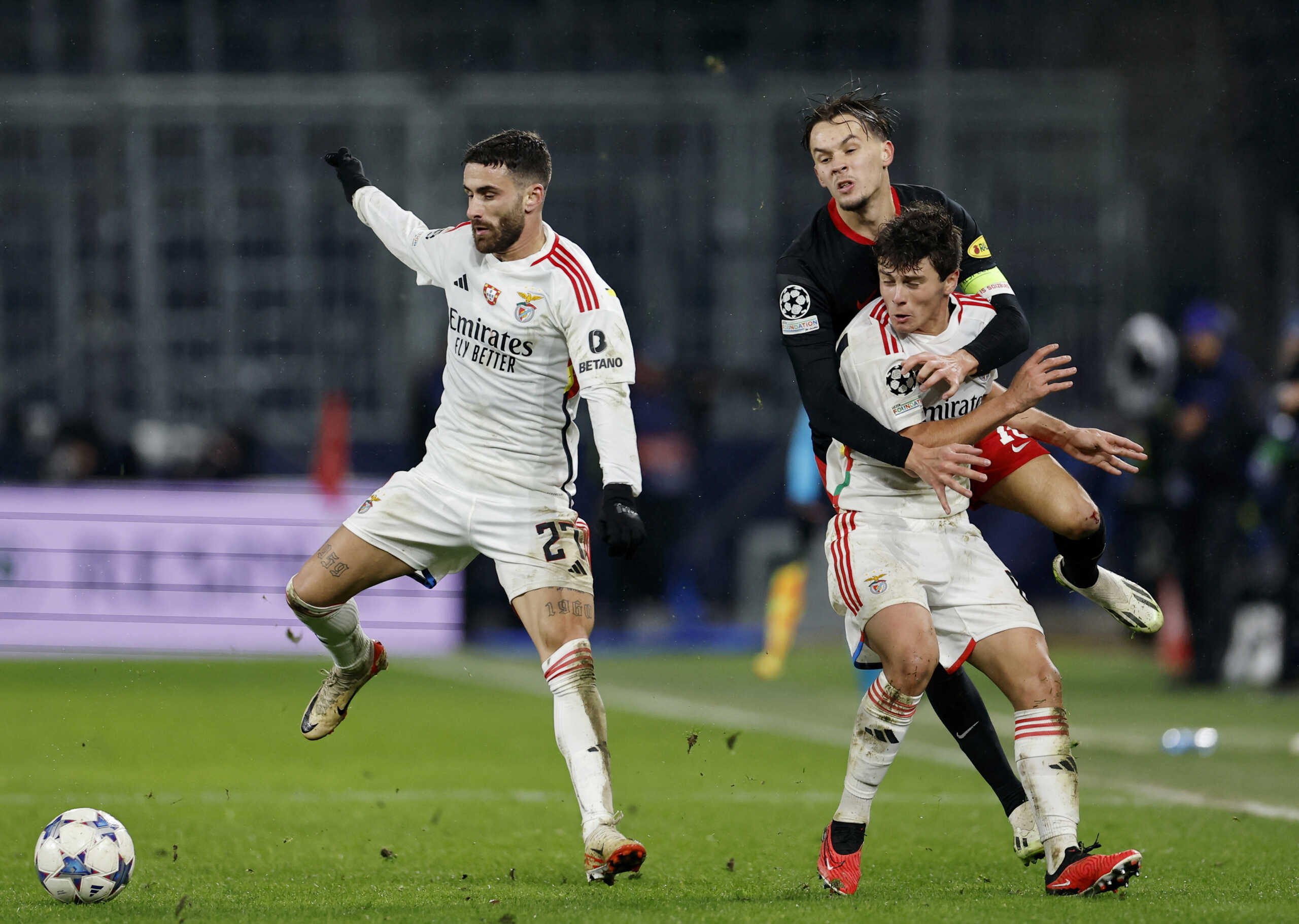 Soccer Football - Champions League - Group D - FC Salzburg v Benfica - Red Bull Arena Salzburg, Salzburg, Austria - December 12, 2023 Benfica's Rafa Silva and Joao Neves in action with FC Salzburg's Amar Dedic REUTERS