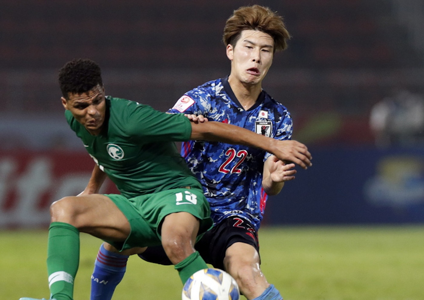 epa08114437 Japan's Daiki Hashioka (R) in action against Saudi Arabia's Khalid Dubaysh (L) during the AFC U23 Championship 2020 group B preliminary round soccer match between Japan and Saudi Arabia at Thammasat Stadium in Pathum Thani, Thailand, 09 January 2020.  EPA