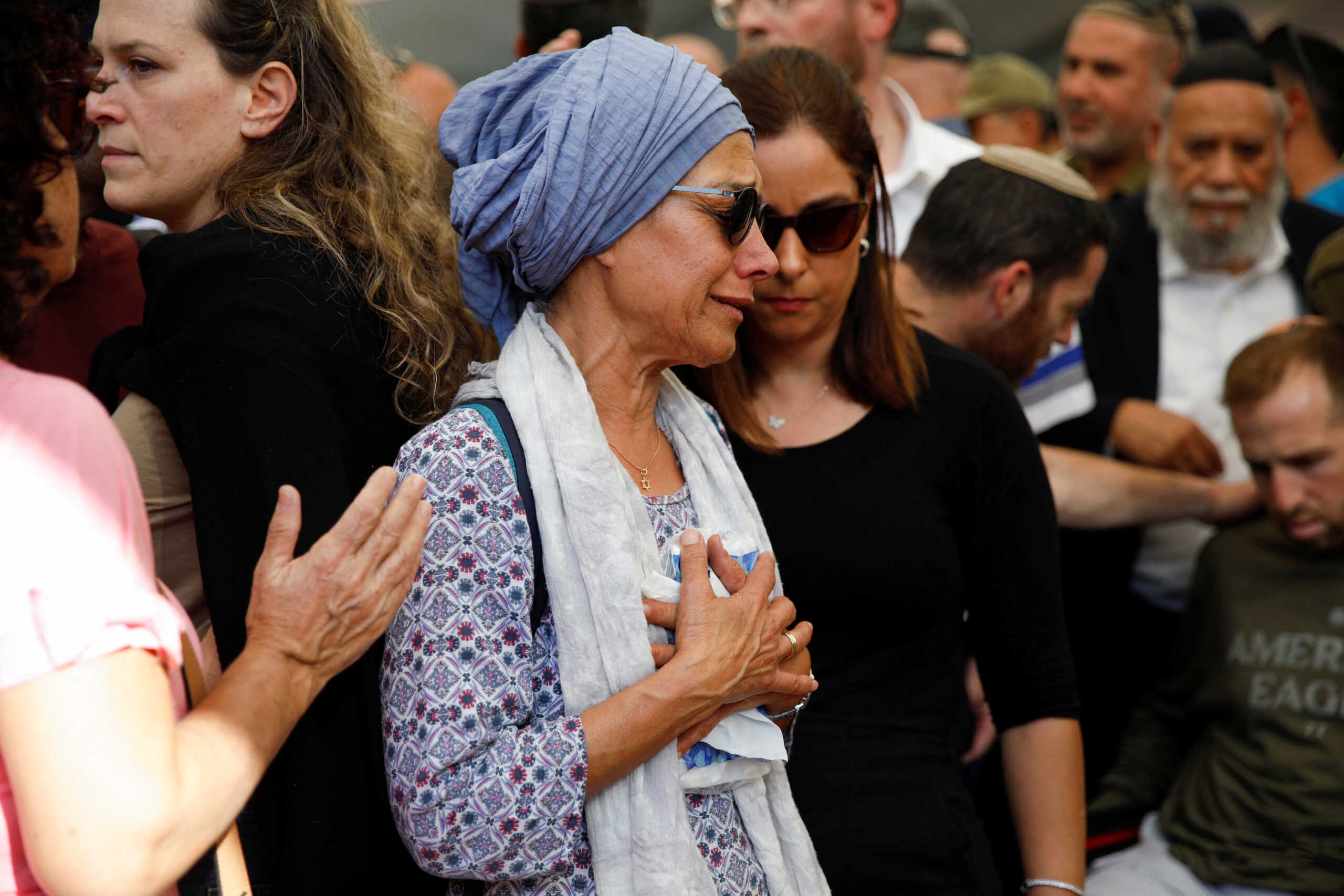 A woman mourns Israeli soldier Colonel Asaf Hamami, who was killed defending Kibbutz Nirim during the deadly October 7 attack by Palestinian Islamist group Hamas, at his funeral in Tel Aviv, Israel December 4, 2023. According to the Israeli army, his body was taken to Gaza by Hamas, but enough findings were gathered to allow for his burial. REUTERS