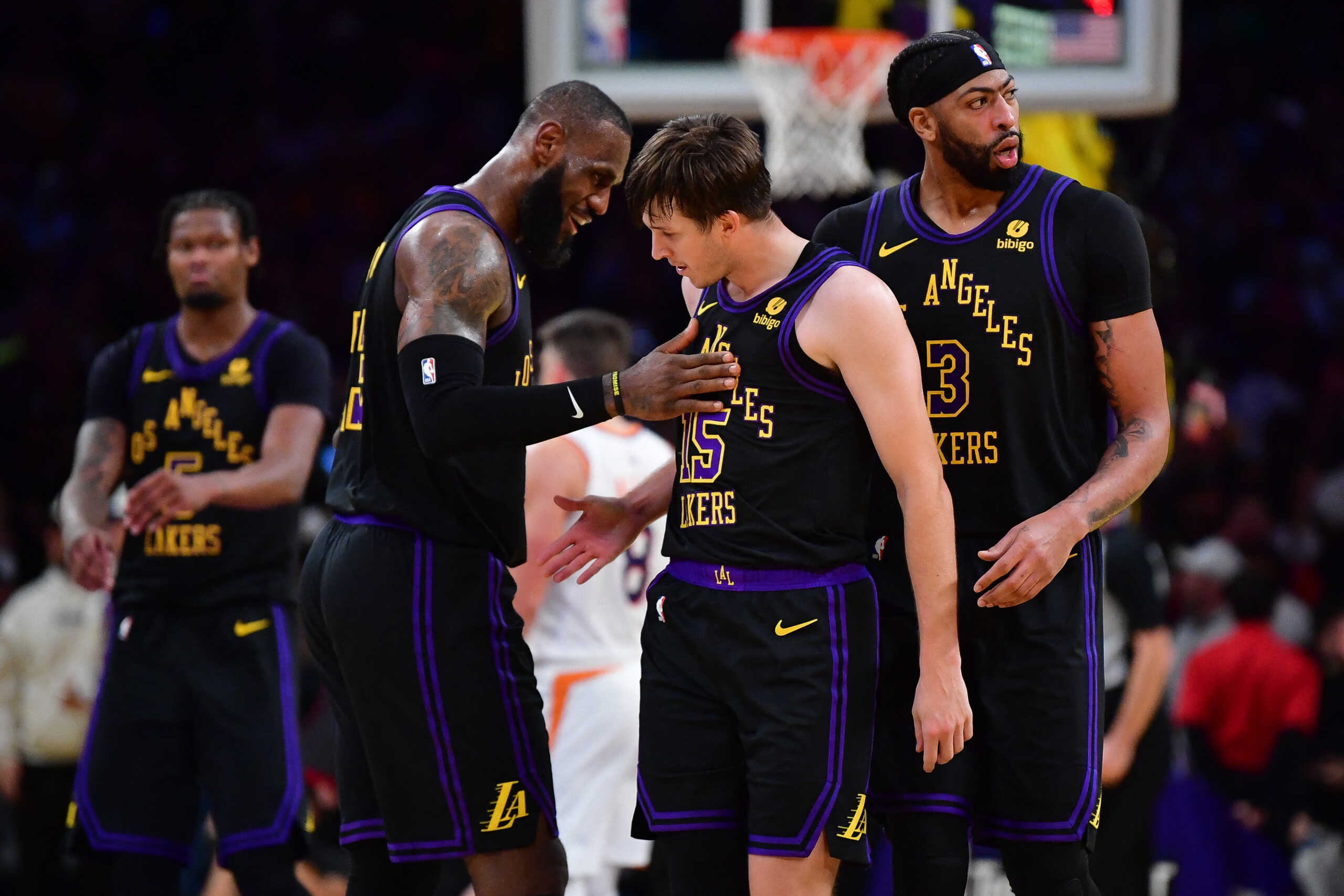 Dec 5, 2023; Los Angeles, California, USA; Los Angeles Lakers guard Austin Reaves (15) reacts after scoring three point basket against the Phoenix Suns with forward LeBron James (23) and forward Anthony Davis (3) during the second half of the In Season Tournament quarterfinal at Crypto.com Arena. Mandatory Credit: Gary A. Vasquez-USA TODAY Sports