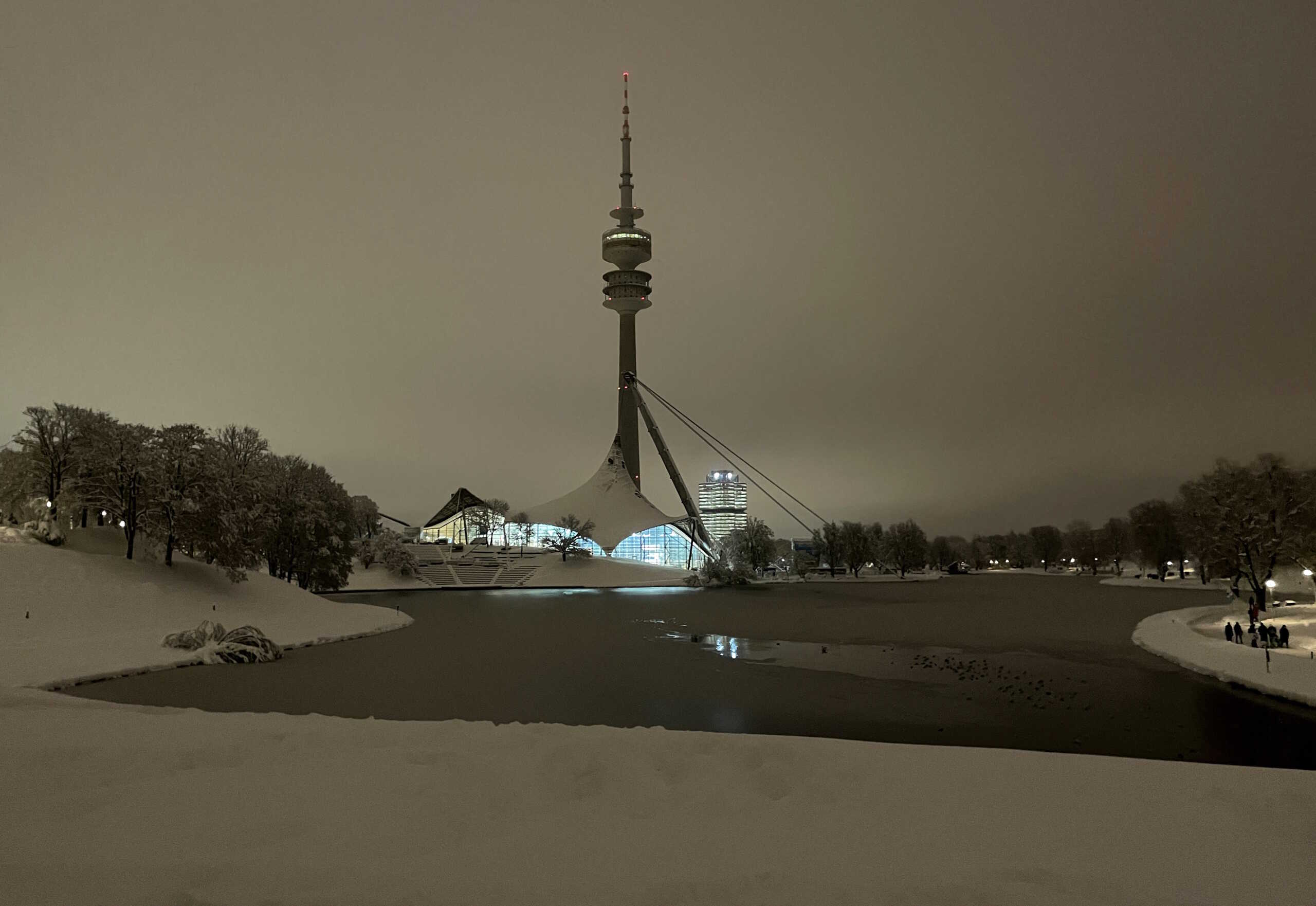 People walk at Olympia Park (Olympic Park), after heavy snowfall hit Bavaria and its capital Munich, Germany, late December 2, 2023. The German Bundesliga soccer match FC Bayern Munich v 1. FC Union Berlin had to be cancelled, trains halted and the airport closed because of the weather condition.   REUTERS
