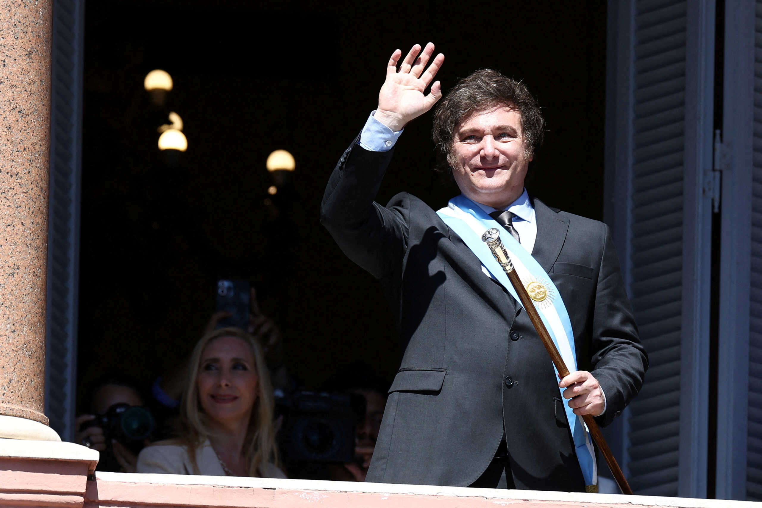 FILE PHOTO: Argentina's President Javier Milei waves to supporters from the Casa Rosada balcony, as his sister Karina Milei looks on, after his swearing-in ceremony, in Buenos Aires, Argentina December 10, 2023. REUTERS