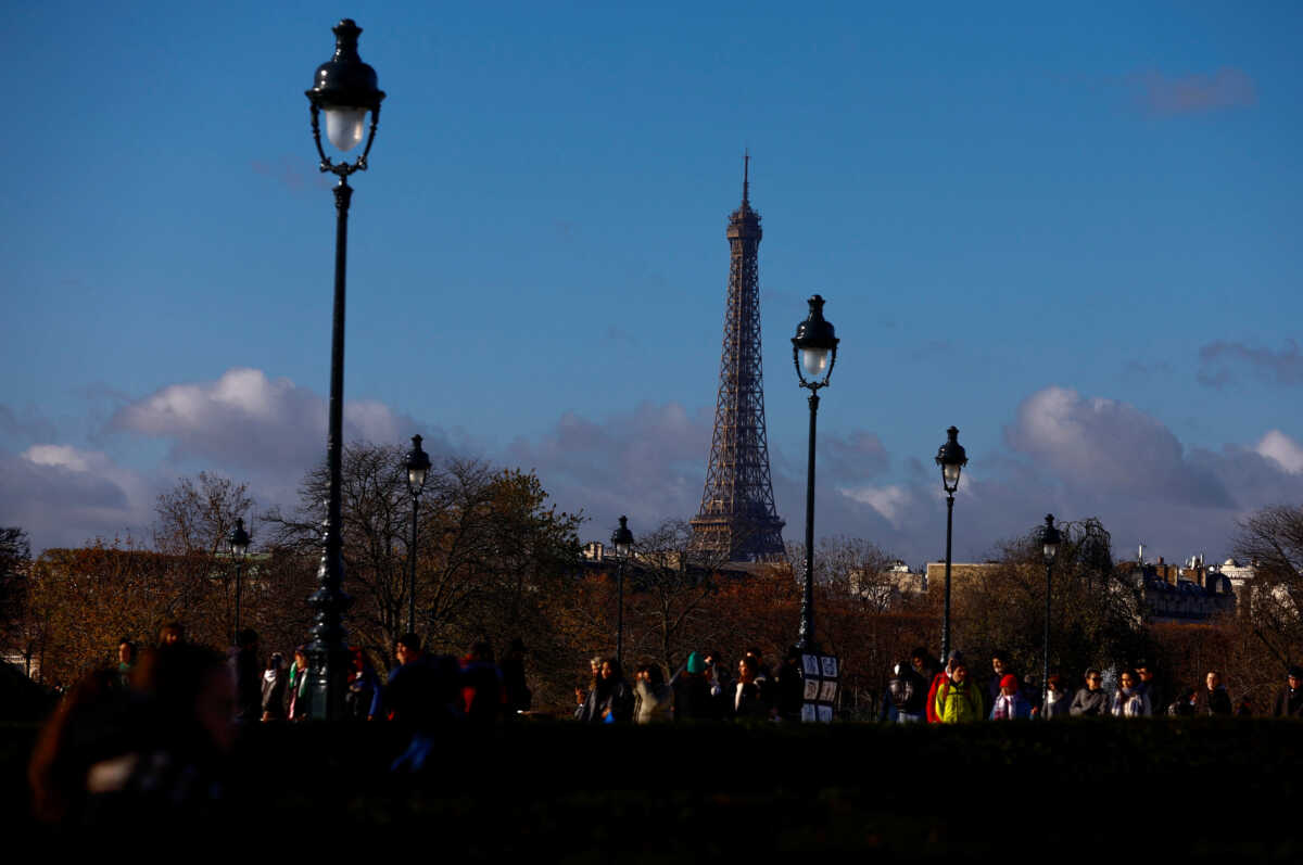 The Eiffel Tower is seen as tourist walk in the Tuileries Gardens, in Paris, France, November 25, 2023. REUTERS