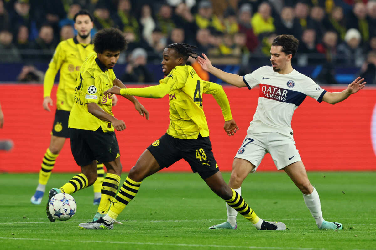 Soccer Football - Champions League - Group F - Borussia Dortmund v Paris St Germain - Signal Iduna Park, Dortmund, Germany - December 13, 2023 Borussia Dortmund's Jamie Bynoe-Gittens in action with Paris St Germain's Vitinha REUTERS