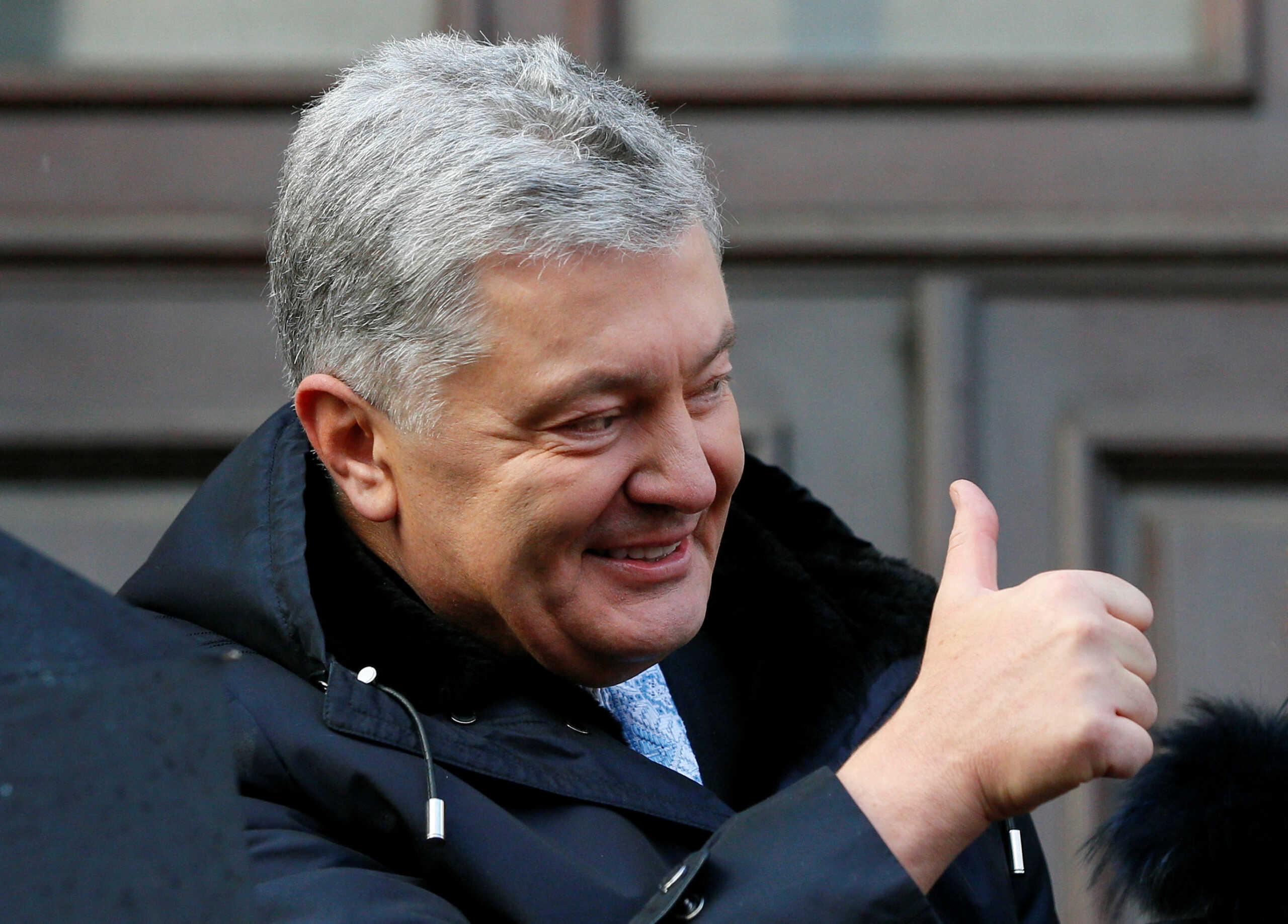FILE PHOTO: Ukrainian former President Petro Poroshenko gives a thumbs-up as he greets supporters after a court hearing in Kyiv, Ukraine January 19, 2022. REUTERS