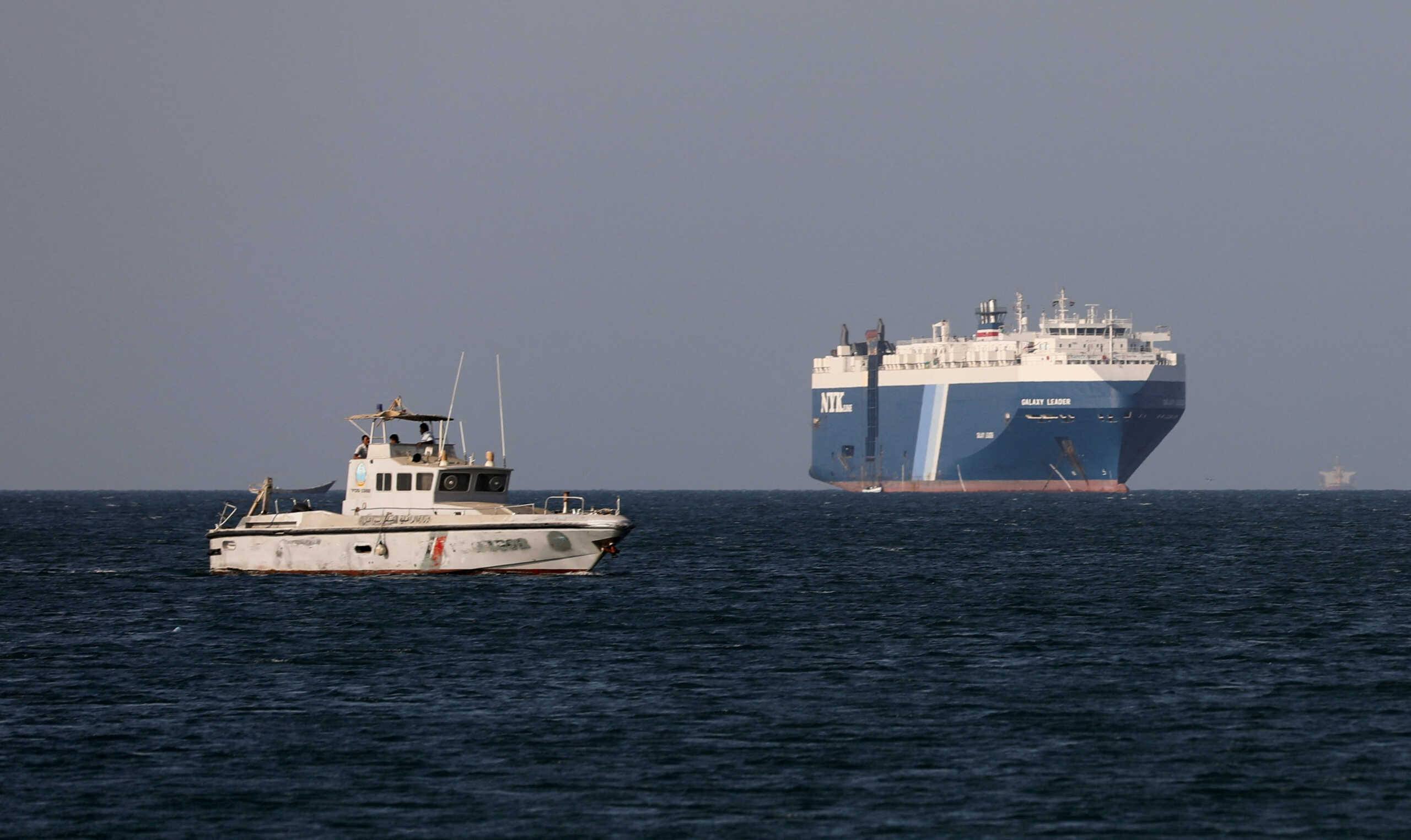 A Yemeni Coast Guard boat sails near the Galaxy Leader commercial ship, seized by Yemen's Houthis last month, off the coast of al-Salif, Yemen, December 5, 2023. REUTERS