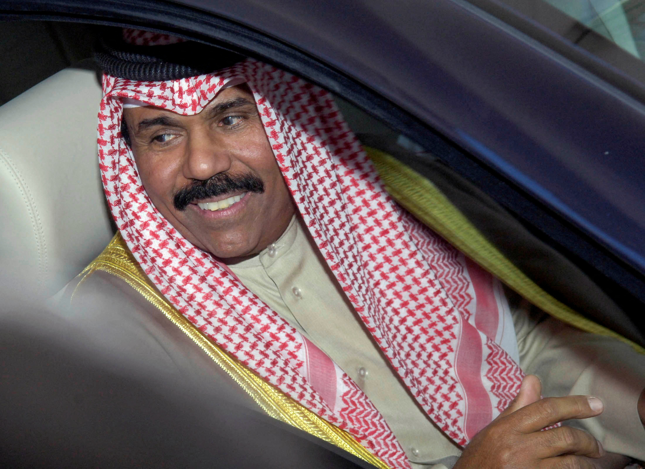 FILE PHOTO: Kuwait's Crown Prince Sheikh Nawaf al-Ahmad al-Sabah leaves Parliament in Kuwait City, Kuwait February 20, 2006. Sheikh Nawaf officially took the position of crown prince after a swearing-in ceremony in Parliament. REUTERS