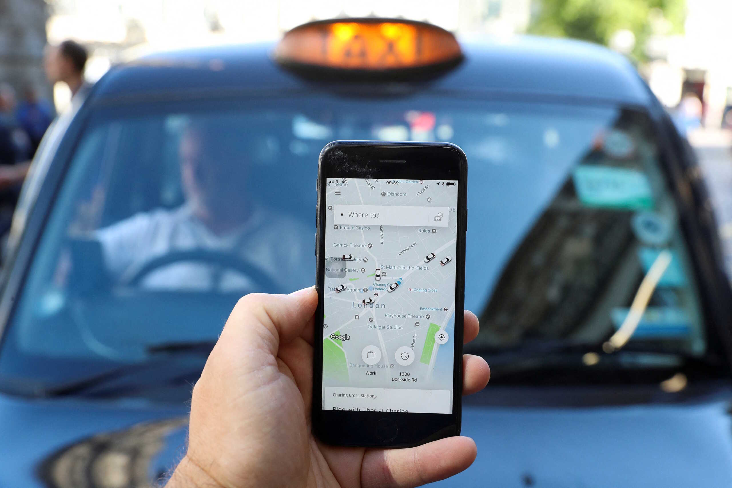 FILE PHOTO: A photo illustration shows the Uber app and a black cab in London, Britain June 26, 2018. REUTERS