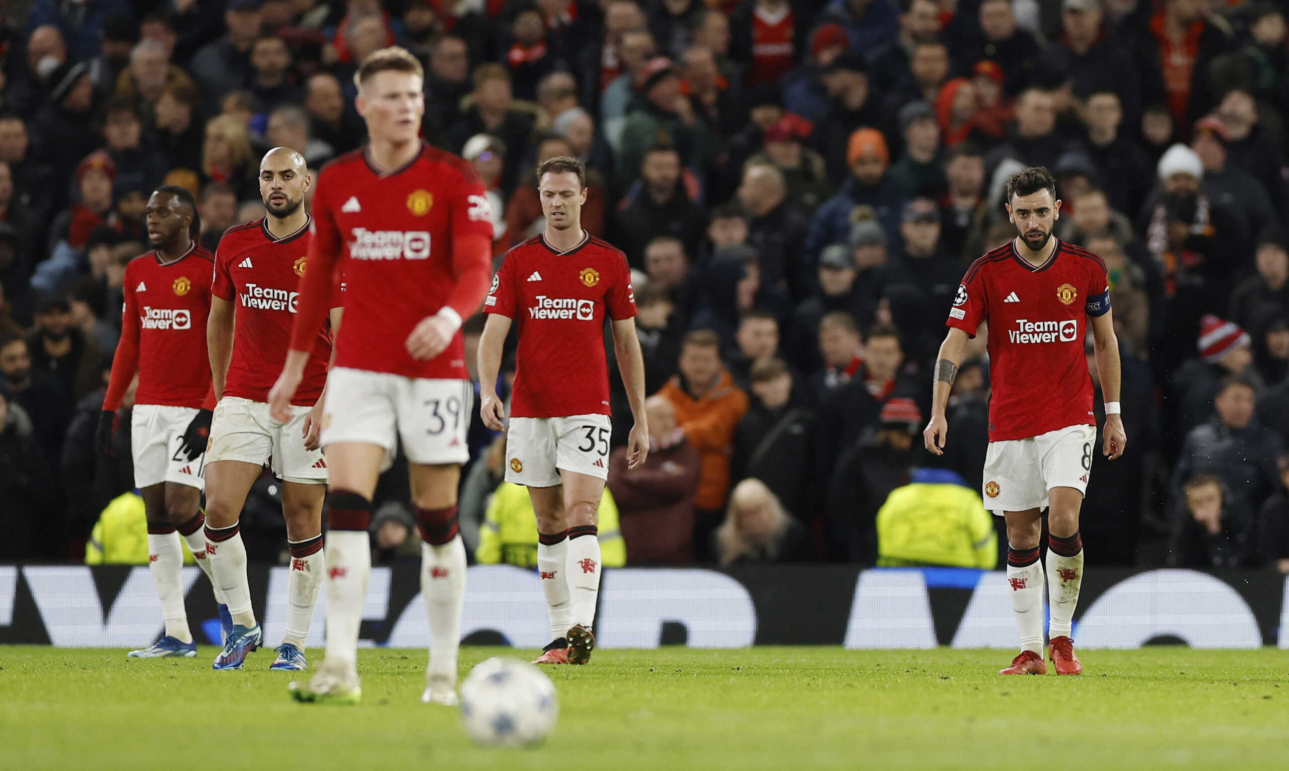 Soccer Football - Champions League - Group A - Manchester United v Bayern Munich - Old Trafford, Manchester, Britain - December 12, 2023 Manchester United's Jonny Evans and Bruno Fernandes look dejected after Bayern Munich's Kingsley Coman scores their first goal Action Images via Reuters