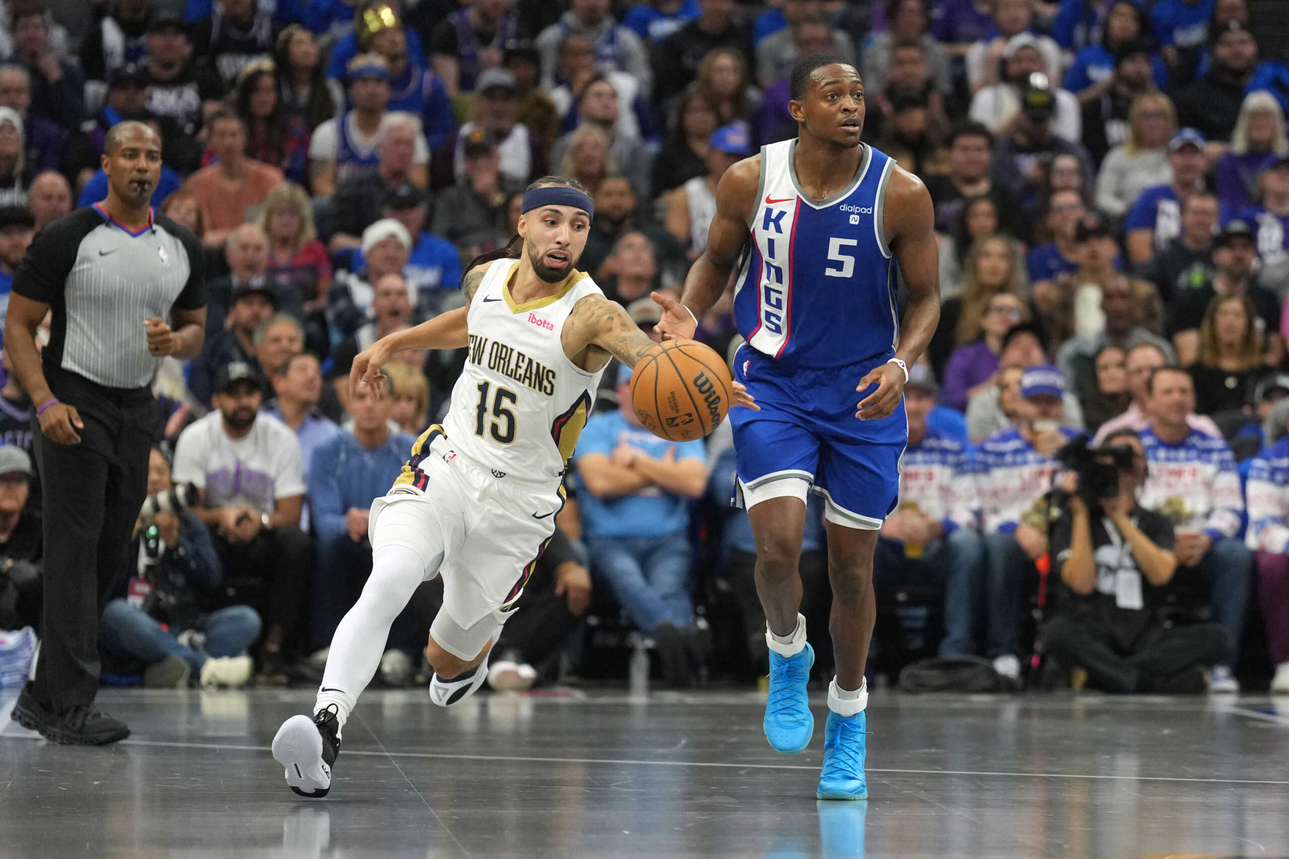 Dec 4, 2023; Sacramento, California, USA; New Orleans Pelicans guard Jose Alvarado (15) steals the ball from Sacramento Kings guard De'Aaron Fox (5) during the first quarter at Golden 1 Center. Mandatory Credit: Darren Yamashita-USA TODAY Sports