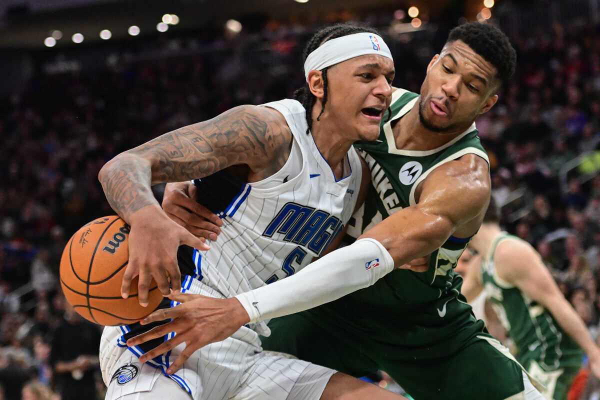 Dec 21, 2023; Milwaukee, Wisconsin, USA; Milwaukee Bucks forward Giannis Antetokounmpo (34) tries to steal the ball from Orlando Magic forward Paolo Banchero (5) in the third quarter at Fiserv Forum. Mandatory Credit: Benny Sieu-USA TODAY Sports