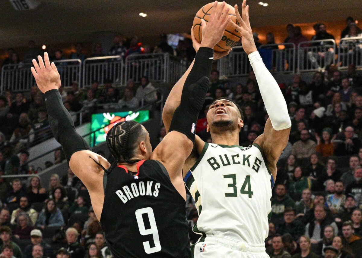 Dec 17, 2023; Milwaukee, Wisconsin, USA; Milwaukee Bucks forward Giannis Antetokounmpo (34) puts up a shot against Houston Rockets forward Dillon Brooks (9) in the first half at Fiserv Forum. Mandatory Credit: Michael McLoone-USA TODAY Sports