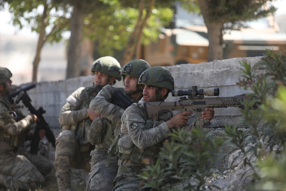 epa08417307 Turkish army soldiers guard the road and prevent civilians from ferrying to ensure protection for the Russian-Turkish joint patrol in Idlib, Syria, 12 May 2020. Turkey and Russia  joint  patrol on the M4 highway was hit by an artillery shell but without damage done.  EPA