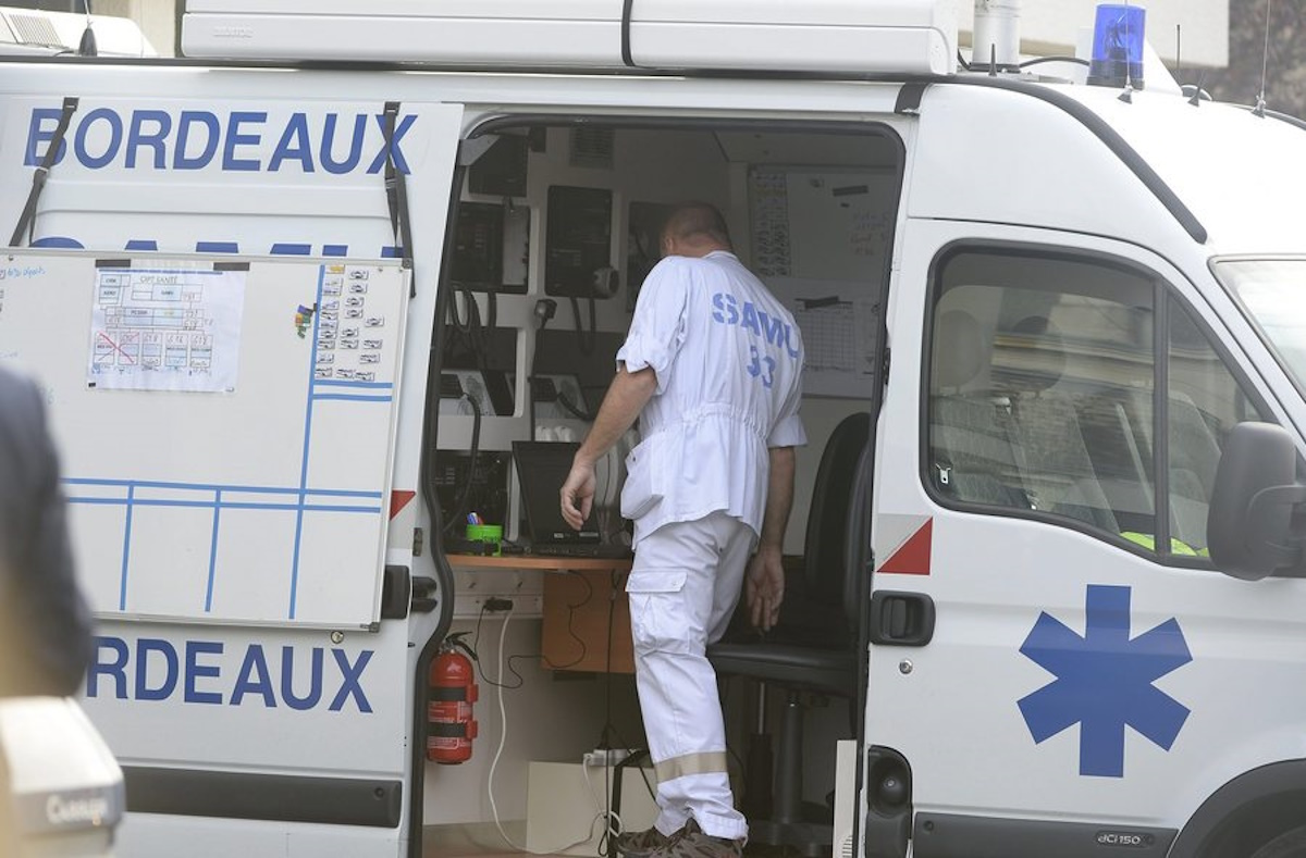 epa04990722 A doctor coordinates help from an ambulance following the fatal bus crash in  in Puisseguin, near Bordeaux, south western of France, 23 October 2015. At least 42 people were killed and several more injured in a collision between a bus and truck in south-western France, the Elysee Palace said.
The bus was carrying senior citizens on an excursion, the Interior Ministry said.
The crash set both vehicles on fire, according to authorities.  EPA
