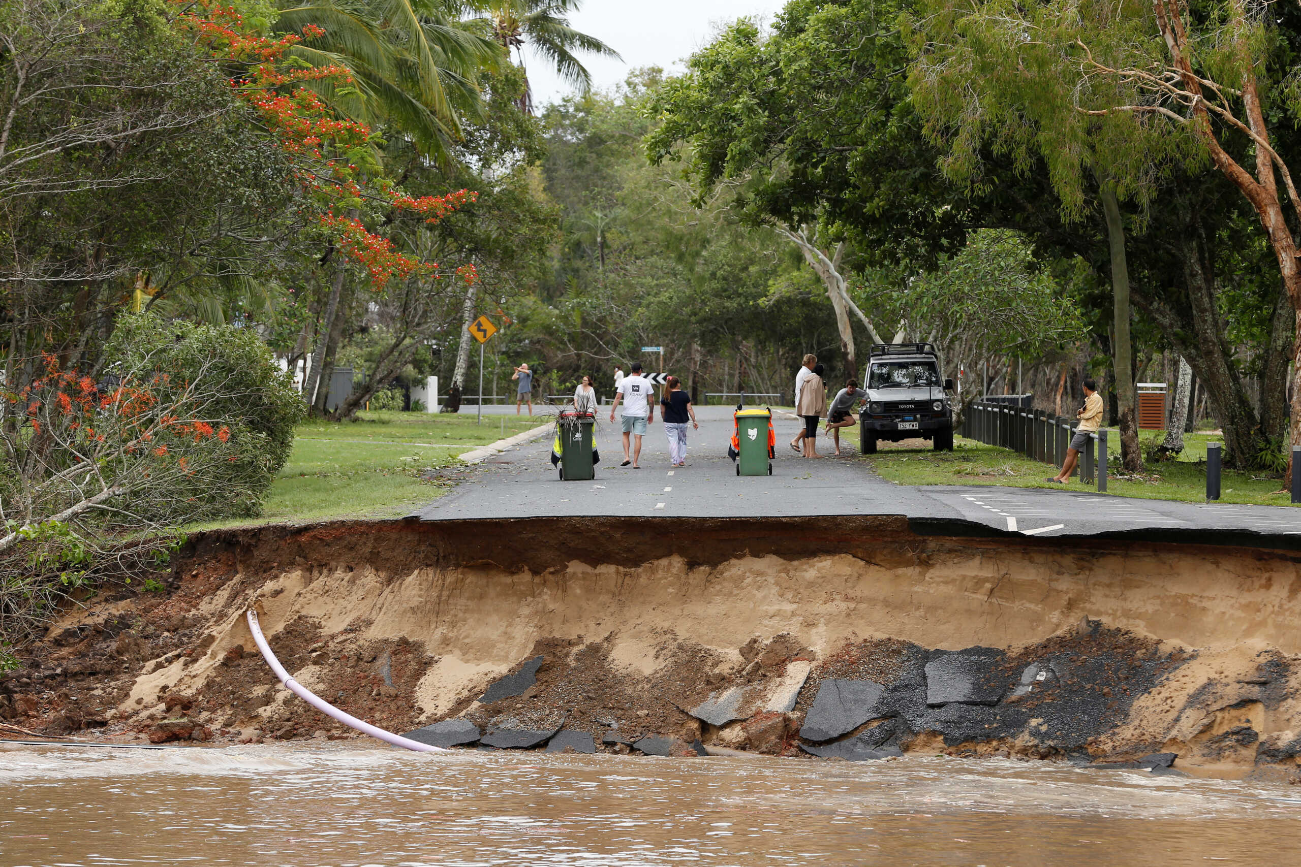 Residents are cut off after a large section of road has washed away at the end of Holloways Beach Esplanade in the suburb of Holloways Beach in Cairns, Australia, December 18, 2023. AAP Image