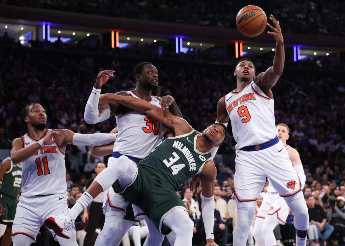 Dec 25, 2023; New York, New York, USA; New York Knicks guard RJ Barrett (9) rebounds in front of Milwaukee Bucks forward Giannis Antetokounmpo (34) and forward Julius Randle (30) during the second half at Madison Square Garden. Mandatory Credit: Vincent Carchietta-USA TODAY Sports