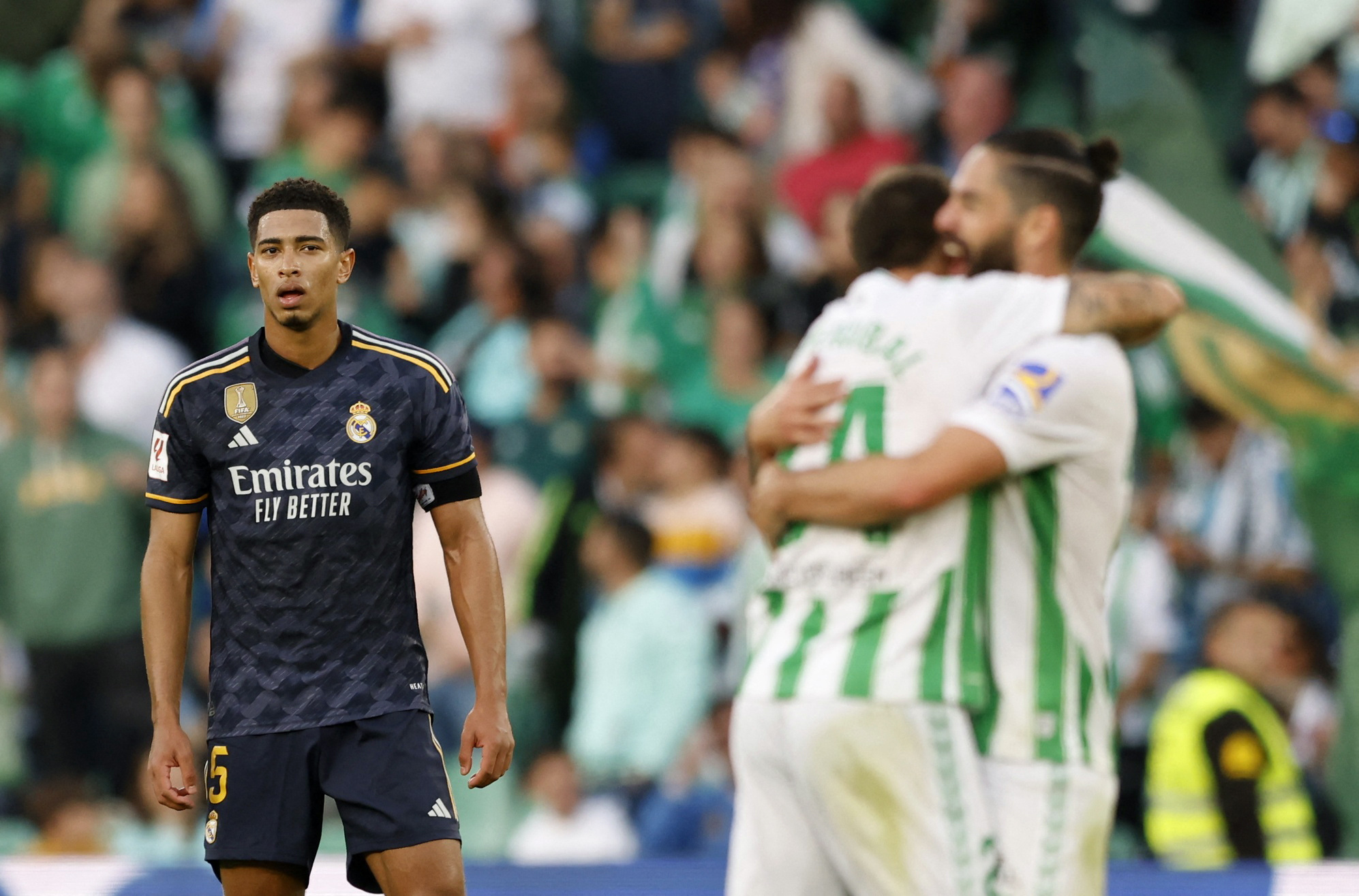 Soccer Football - LaLiga - Real Betis v Real Madrid - Benito Villamarin, Seville, Spain - December 9, 2023 Real Betis' Aitor Ruibal celebrates scoring their first goal with Isco as Real Madrid's Jude Bellingham looks dejected REUTERS