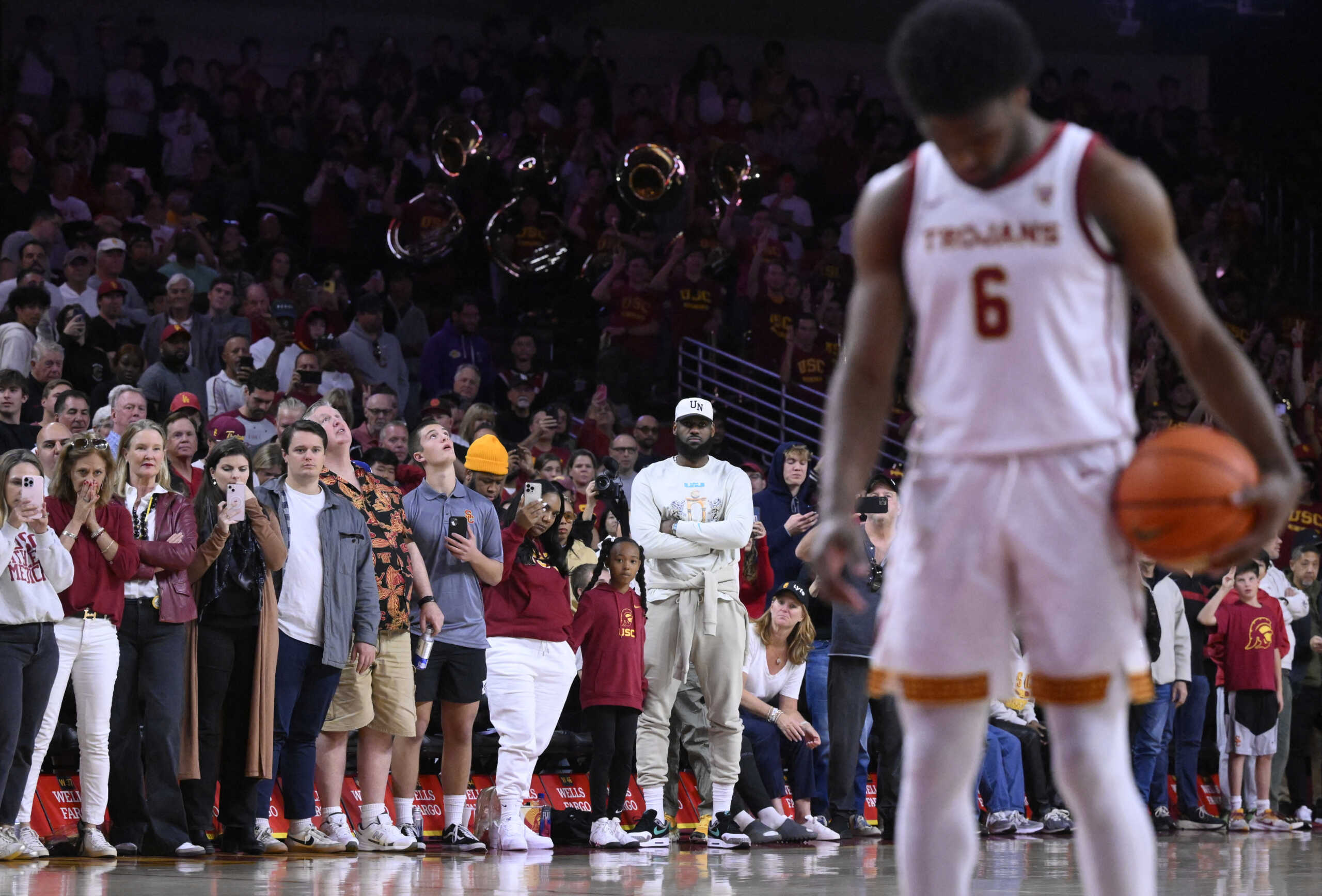 Dec 10, 2023; Los Angeles, California, USA; USC Trojans guard Bronny James (6) shoots a free throw in the closing minute against Long Beach State 49ers as his family looks on at Galen Center. Mandatory Credit: Robert Hanashiro-USA TODAY Sports