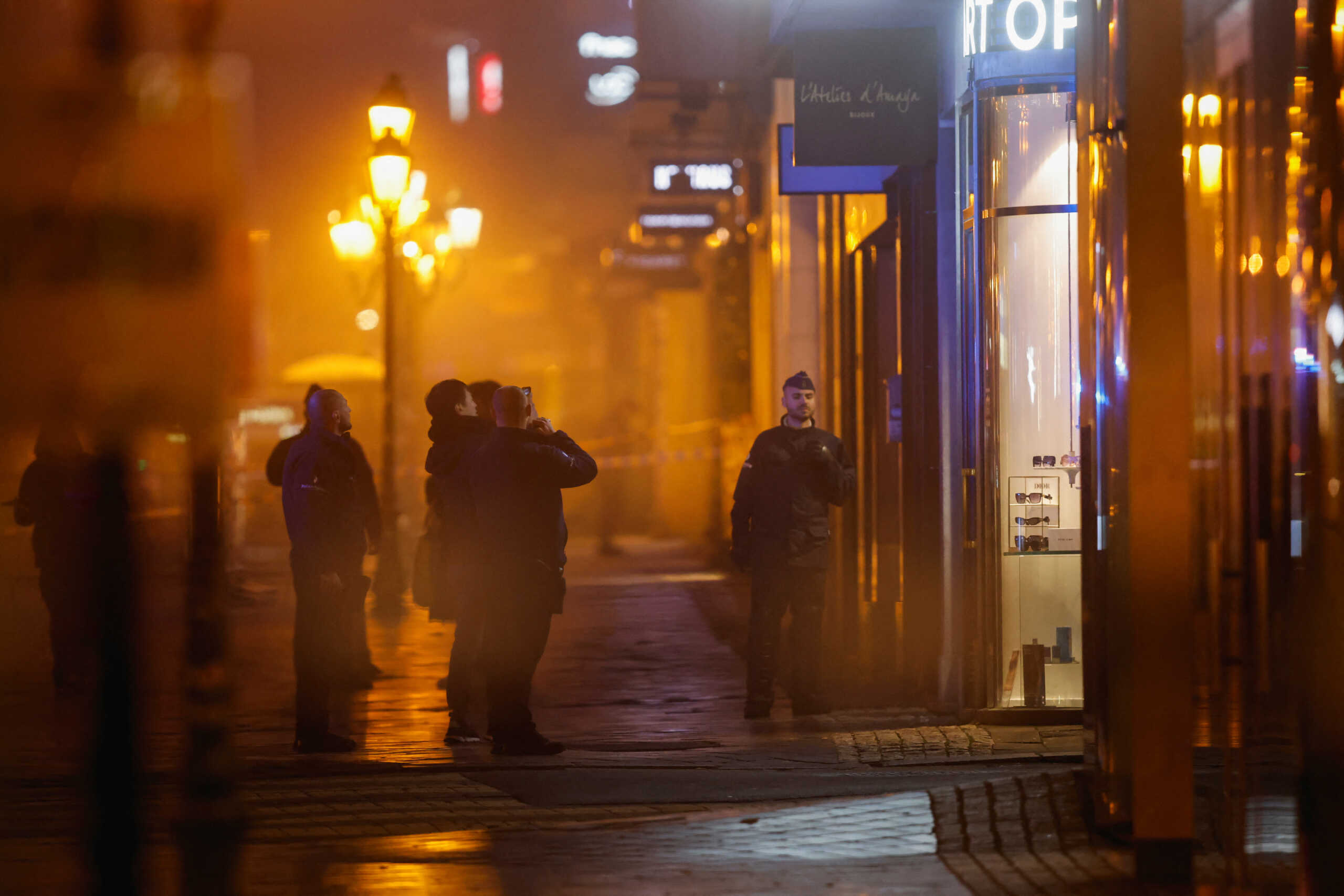 Belgian police officers keep guard outside the area where, according to police, a shooting took place, injuring several police officers, in Brussels, Belgium, December 6, 2023. REUTERS