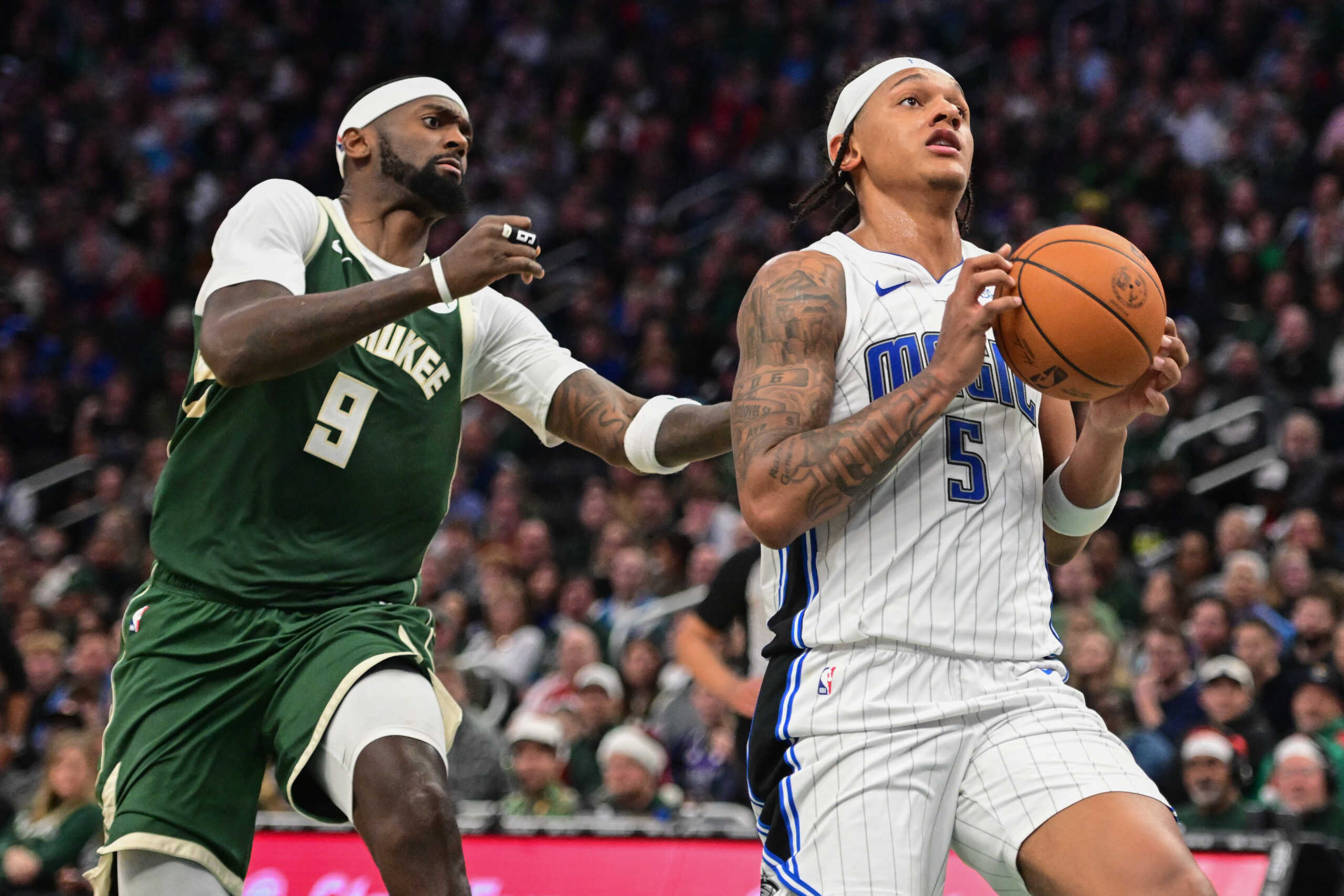 Dec 21, 2023; Milwaukee, Wisconsin, USA; Orlando Magic forward Paolo Banchero (5) takes a shot against Milwaukee Bucks forward Bobby Portis (9) in the third quarter at Fiserv Forum. Mandatory Credit: Benny Sieu-USA TODAY Sports